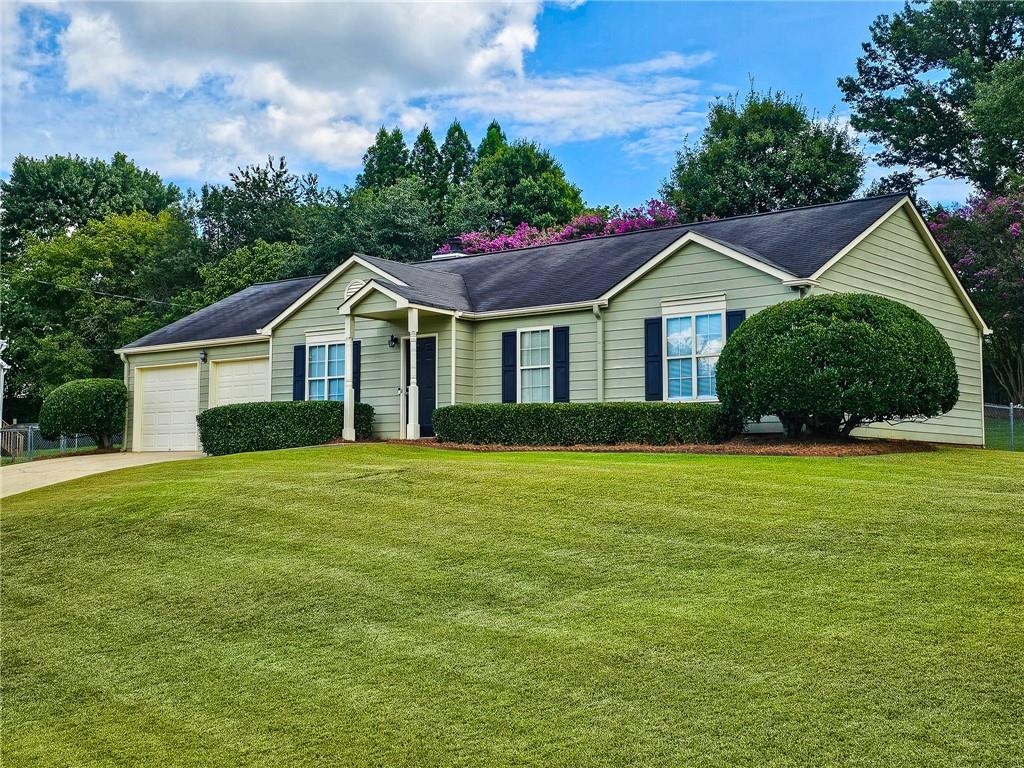 Check out the 3D virtual tour! This 3 bed 2 full bath immaculate ranch home sits perfectly on an extra large corner lot with pristine landscaping. It boasts gleaming hardwood floors, a spacious living room with fireplace and vaulted ceilings. The kitchen has an eat-in area, pantry, and and easy access to the 2 car garage for carrying in groceries. Adjacent sliding doors lead you to the back yard. The primary bedroom has an ensuite full bathroom, walk-in closet and room for a sitting area. One of the two other bedrooms makes the perfect office/den space. Venture outdoors to see the patio and large landscaped private back yard with lush views. The 2-car garage and driveway have plenty of parking for multiple cars. Located in the desirable Cherokee County school district and just minutes to historic Woodstock and convenient to downtown Roswell, and major roads.