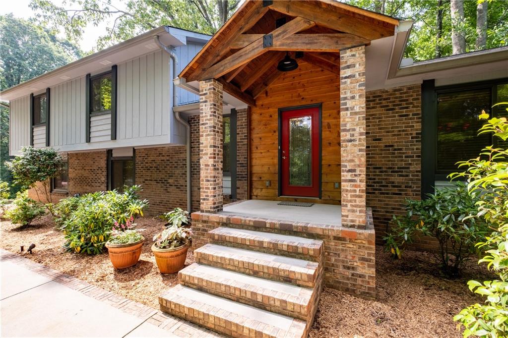 Fully renovated 3 bedroom, 2 bath, 2055sf home with a stand-alone custom designed 1280sf office and studio. The office and studio area includes a half bath, large windows, closets for storage and 2 separate offices; all heated and cooled. Nestled in a quiet, picture-perfect neighborhood minutes from thriving Downtown Roswell, this highly sought after Roswell location is convenient to Alpharetta, Crabapple, GA 400 and top ranked Fulton County schools - it's the best of all worlds! This stunning home has a custom kitchen with stained oak cabinets, granite countertops, leaded glass window and many other designer features. Gleaming white oak hardwood throughout. The main bedroom includes leaded glass transoms above the doors, a custom designed walk-in closet and the most exquisite bath you will ever see! The oversized solid surface soaking tub, antique stained-glass window and marble tile floor and shower add to the feeling of total luxury. A 3-level patio looks out into a peaceful back yard featuring custom stone benches, large boulders, and magnificent oak and hickory trees. With the additional 1280sf of living space, the stand-alone office and studio can serve as a work-from-home retreat, headquarters for a home-based business or even an entertainment area. The possibilities are endless! A new driveway and septic system were installed in 2021, the second bath was renovated in 2022 and the entire interior and exterior of the home were professionally painted in 2023.