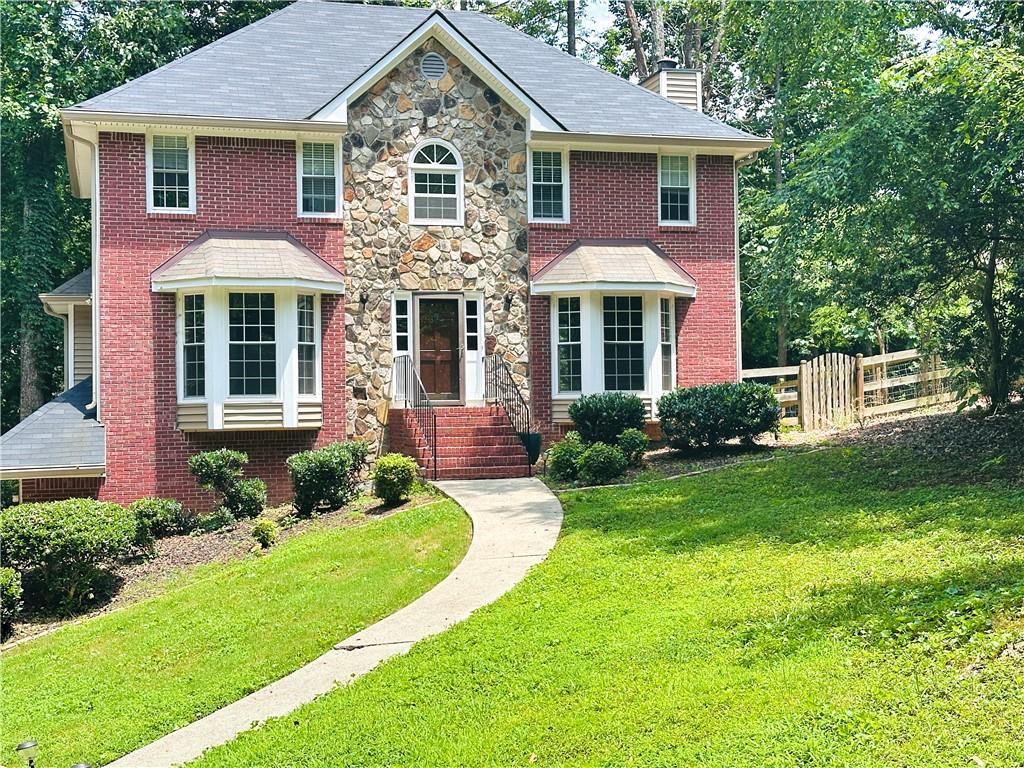 Beautifully renovated traditional residence situated in a prime location! This home features 3 bedrooms and 2.5 bathrooms, along with a basement, all in a prime location served by Cobb Schools of excellence. The gourmet kitchen with breakfast area boasts quartzite countertops. An upgraded master bathroom, smart home lighting, Nest thermostat and fresh paint are additional enhancements. The home also includes two built-in bookcases and a bonus closet in the master suite. A large window overlooks the master tub, complemented by walk-in closets. Host gatherings with friends and family in front of the sunken stacked stone fireplace. The fantastic private lot is nestled among trees, providing a serene environment. Enjoy relaxation on the renovated back deck. Conveniently located near I-575, I-75, KSU, Town Center Mall, Publix, Kroger, Starbucks, Home Depot, Lowe's, and much more!