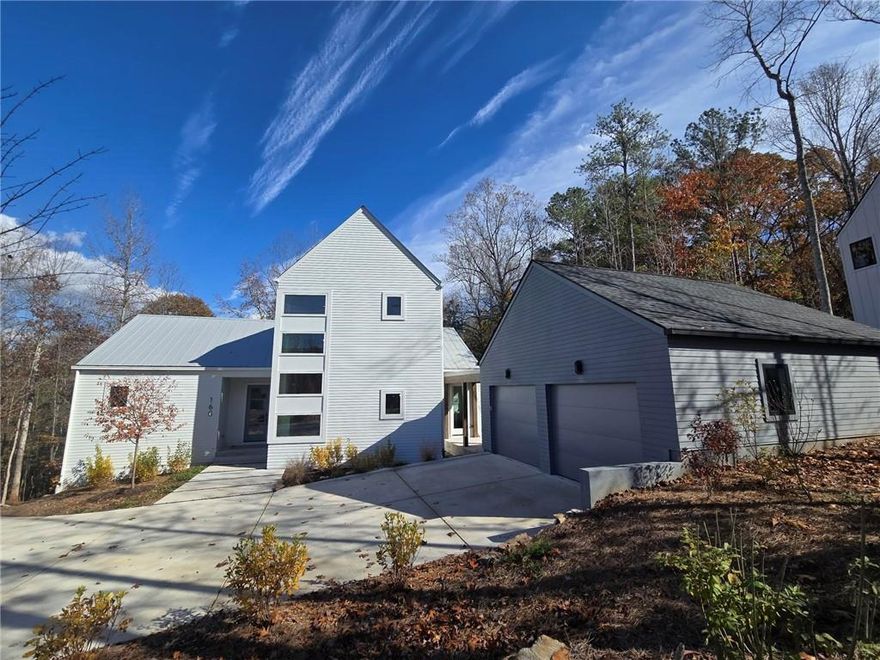 MOVE-IN READY!  Welcome to 160 Cedarwood Lane in the Aster community of Roswell, GA by Brightwater. One Acre, Solar Panels Included, Cul De Sac, Private.  This 5,017 square foot wooded cul de sac home offers 4 bedrooms and 4.5 bathrooms, blending modern style with a Bauhaus edge for a distinctive living experience. The terrace has over 1,000 sq ft finished with 3 large rooms and 10 Ft ceilings in the largest of the rooms.

The primary suite is conveniently located on the main level, providing a private retreat with all the comforts you desire. A freestanding tub and frameless shower are accompanied by dual vanities. There is also a custom primary closet system installed and it is plumbed for a washer and dryer.  The home includes a dedicated work-from-home space downstairs, perfect for maintaining productivity in a quiet, comfortable environment. Additionally, three finished living spaces in the terrace level offer ample room for relaxation and entertainment.  The second level has a generous laundry room and 3 additional secondary bedrooms with private en suites.

The Curated Interior Design is "Moody Modern". Characterized by simplicity, sophistication, and a focus on functionality. Natural materials like light wood and textures are complemented by dark modern accents, creating a balanced and inviting atmosphere.  The kitchen features natural wood tones and crisp accents, beautifully coordinated with soft white quartz countertops and an elegant backsplash. Premium Thermador Appliances including 48" Thermador Pro Range with Double Oven and a Thermador Counter Depth French Drawer Refrigerator is installed.  Windows over the sink bring the outside in, while an oversized island with waterfall ends anchors the space and overlooks the dining room.  The spacious walk in pantry has custom shelving.

The family room boasts a dramatic full wall fireplace design, beckoning you to enjoy this harmonious living space. Triple sliding glass doors fully open to truly bring the outdoors in, enhancing the seamless connection between indoor and outdoor living.  There is a very large covered porch with a tongue and groove stained ceiling and stairs are built to the side yard.

Modern design meets practical functionality in a beautiful, sustainable home.

This home is a Net Zero Energy Home featuring Solar Panels, Spray Foam Insulation is in the Attic envelope of the entire home and exterior walls, 18 Seer HVAC and Tankless Water Heater.   Aster features an amenity area with fire pit, activity lawn, unstructured play area and nature trails throughout the community.  Roswell is Named One of the Top Three Cities in the Nation to Raise Your Family, released by Frommer's.