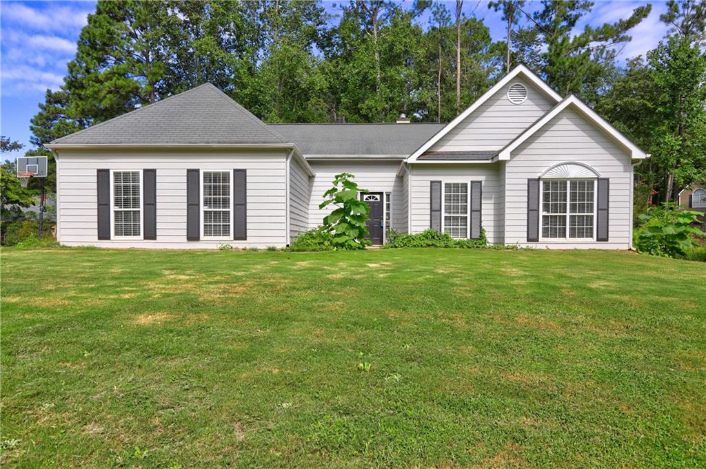 Welcome to Wyngate: one of the most desirable communities in Towne Lake! Near-perfect home on a large corner lot, walking distance from the main pool. This meticulously cared-for 3-bedroom, 2-bathroom residence boasts an inviting open concept design, high ceilings, fresh interior paint, and a peaceful corner lot location. The main floor radiates warmth and brightness, showcasing a thoughtfully designed layout. Featuring a generous space, Hardwood flooring throughout, a pristine white cabinet kitchen outfitted with stainless steel appliances, a stylish tiled backsplash, and elegant granite countertops. The spacious master retreat impresses with a vaulted ceiling, an en-suite bathroom featuring a double sink, a relaxing soaking tub, and a roomy walk-in closet. Secondary bedrooms are roomy. Outside, you'll find a cozy and manageable backyard area, fire pit, ideal for outdoor gatherings. Enjoy a private, low-maintenance backyard with a perfect hangout spot. Wyngate's minimal HOA provides homeowners access to two pools, several tennis courts, pickleball courts, a clubhouse, and a playground. Don't forget about the benefits of Wyngate: top-rated schools, ample shopping and dining, and easy access to Hobgood Park, walking trails, Lake Allatoona, golf courses, and more. Located minutes from Downtown Woodstock, Canton, and Lake Allatoona, and zoned for excellent schools—this home has it all!