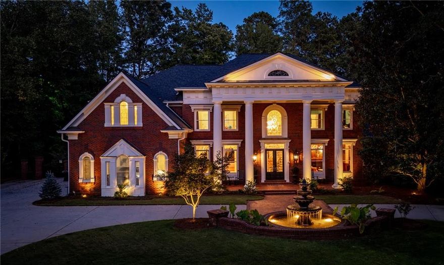 Welcome to your private sanctuary in the heart of Country Club of the South, located in highly desirable Johns Creek! This traditional Georgian estate, beautifully positioned on 1.4 luxuriant acres, offers elegance & tranquility at every turn. The circular drive w/ illuminated fountain sets the tone for the grandeur of this exceptional property graced with the backdrop of the award winning Jack Nicklaus golf course. The home’s spectacular backyard oasis promises to captivate and impress with its heated saltwater pool & spa, soothing water feature & sweeping pool deck for lounging in the sun. The certified backyard by Birds of Georgia is a wildlife habitat set amidst a breathtaking landscaped paradise that includes a plethora of flowering greenery, unique trees & charming brick and stone paths. The grand entry welcomes you into the foyer with soaring ceilings that flood the home with natural light. A wood-paneled library w/ grass cloth wall covering & fireplace offers a sophisticated space to work or unwind. The two-story great room, with its intricate inlaid hardwood floor and exquisite barrel ceiling with extensive millwork and fireplace, is a showstopper for entertaining.The chef’s kitchen, with white cabinetry, granite countertops, 6-burner Wolf stove, double ovens, island & spacious pantry, flows effortlessly into the breakfast room and fireside keeping room while offering picturesque views of the serene backyard & pool. The sumptuous primary suite on the main offers tranquil natural views and is a spa-like haven w/dual custom closets and heated floors. Upstairs, a second master suite features new hardwood floors, double oversized closets, a cozy fireside sitting area, and spa bath with tile flooring and custom cabinetry. Two additional spacious secondary en-suite bedrooms offer privacy & comfort for family and visitors. The impressive terrace level boasts new travertine floors, a bar/kitchen area with dishwasher, refrigerator and wine cabinet all overlooking an inviting sitting area w/fireplace and direct access to the outdoor living. A private media room, mirrored exercise room w/ full bath, two additional en-suite bedrooms and extensive storage areas complete this level.  A charming brick breezeway draws you outside to the meticulously designed outdoor living spaces that surround the pool, offering endless opportunities for relaxation and entertainment. Enjoy the sweeping custom paver deck, gas fire pit & outdoor kitchen, all accented with soft lighting for enchanting evenings under the stars. Every detail of this estate reflects impeccable craftsmanship and striking architectural features. With endless opportunities for enjoying exceptionally designed indoor & outdoor living spaces, this home is truly a one-of-a-kind and ready for worry free move it! The security, amenities & access to top rated schools, make Country Club of the South the place to live! Come witness the unparalleled lifestyle offered by this breathtaking estate!