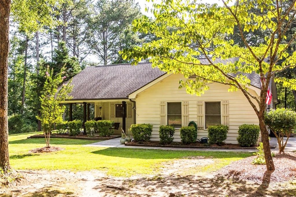 **Now offering $8,500 in seller concessions!** Welcome to 810 Northlake Circle, a well-maintained 3-bedroom, 2-bath home with an additional office/flex space, nestled on a quiet 1.9-acre lot in a peaceful Oxford neighborhood. Inside, you'll find luxury vinyl plank flooring throughout and an open-concept layout that seamlessly connects the kitchen, dining area, and living room. A wood-burning fireplace adds warmth and charm to the living space, making it ideal for both relaxing and entertaining. The primary suite features tray ceilings, a walk-in closet, and a spacious en-suite bath with a soaking tub, separate shower, and dual vanities. Two additional bedrooms and a flexible additional room offer space for guests, work, or hobbies. Enjoy outdoor living on the rocking chair front porch or back patio, and take advantage of the recently installed 27ft, saltwater above-ground pool and included storage shed. The partially cleared 1.9-acre lot provides privacy along with plenty of flat usable space. Move-in ready and full of features, this home offers the best of country living with modern comfort. Schedule your showing today and see all that 810 Northlake Circle has to offer!