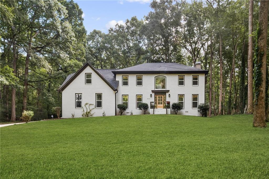Tucked away in the picturesque Brandon Park neighborhood, this beautifully remodeled 3,044 sq. ft. two-story home offers the perfect blend of privacy, charm, and modern comfort. Set on nearly 1.5 wooded acres, the property welcomes you with a winding driveway that crosses a scenic creek via a bridge flanked by hydrangeas. Inside, every inch has been thoughtfully renovated from top to bottom. The main level features a half bath, two inviting living rooms, a formal dining room adorned with a breathtaking woodland mural that brings the outdoors in. An open-concept kitchen features sleek cabinets, quartz countertops, a stylish tile backsplash, and brand-new stainless steel appliances with a large island, breakfast nook, and plenty of natural light. Upstairs, the luxurious primary suite boasts a picture window framing serene views of the property. The primary bath is a dream, with vaulted ceilings, dual vanities, huge soaking tub and large shower. Four additional bedrooms and updated bathroom with double sinks provide space for family and guests alike. All bathrooms have been completely redone with updated tile, tubs, vanities, mirrors, and toilets. New light fixtures, outlets, switches, and plates throughout the home enhance both style and functionality. The exterior has been refreshed with a brand-new roof, all new vinyl double-pane windows, and fresh paint. Step outside to enjoy a private, expansive backyard — complete with a brand-new iron fence to keep children and pets secure — immersed in nature. Soak in the surroundings by lounging on the deck or conversing around the fire pit. With two brand-new AC units, a new water heater, and brand new septic system, this home is move-in ready with all major systems updated for peace of mind. Conveniently located near shopping, dining, and top-rated schools, 300 Creekview Trail offers a perfect blend of comfort, style, and modern living.