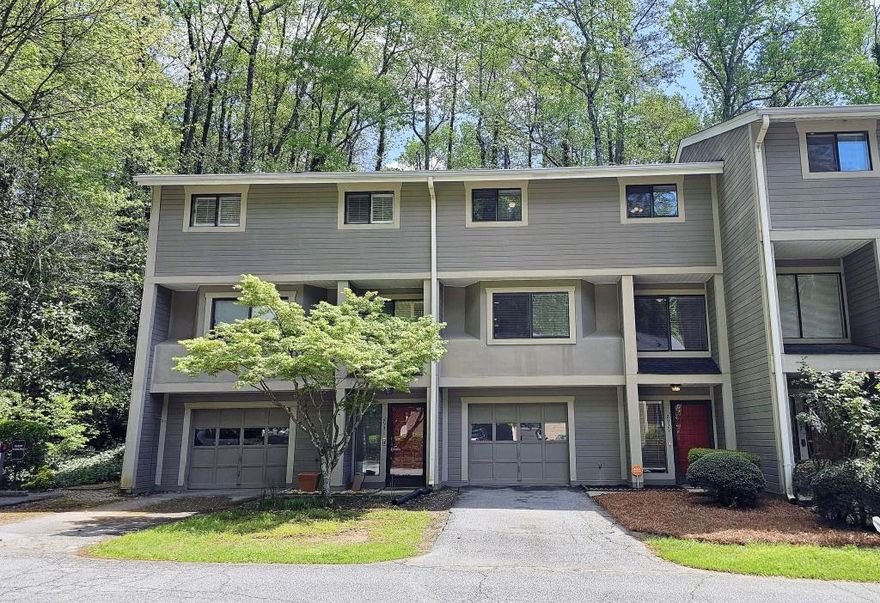 Charming Condo in The Sought-After Woods - Walk to The Battery! Discover this beautifully updated 3-bedroom, 2.5-bath condo in The Woods-one of the area's most desirable communities! This prime location offers walkability to The Battery, shopping, Greenways, and the Chattahoochee River, blending convenience with nature. Inside, you'll find new paint, hardwood floors, and a cozy wood-burning fireplace in the spacious living area. The eat-in kitchen and formal dining room provide plenty of space for entertaining. Step outside to a private patio overlooking serene wooded views-the perfect retreat. Additional features include a one-car garage and ample storage. Ideal for first-time buyers or investors, this home is a fantastic opportunity in a high-demand area. Don't miss out-schedule your showing today!