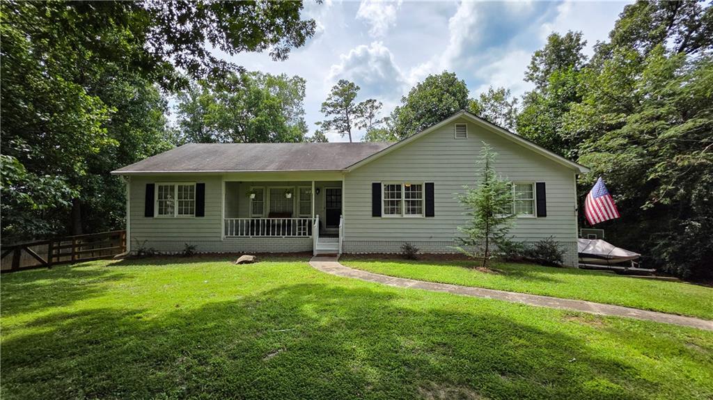 Discover privacy and convenience in this stunning ranch-on-a-basement home, just 4 miles from downtown Woodstock's vibrant shops, dining, and events!! Inside, enjoy a huge chef's kitchen with stainless steel appliances and custom cabinetry, complemented by open living areas and a new HVAC system for ultimate comfort. The finished basement offers versatile potential for a home office, gym, and/or media room. The oversized two-car garage provides ample storage/workshop/vehicle space (fits a full sized truck!), while the backyard features a pristine Gunite in-ground pool--perfect for gatherings or relaxation. Don't miss this opportunity! Schedule a showing today.