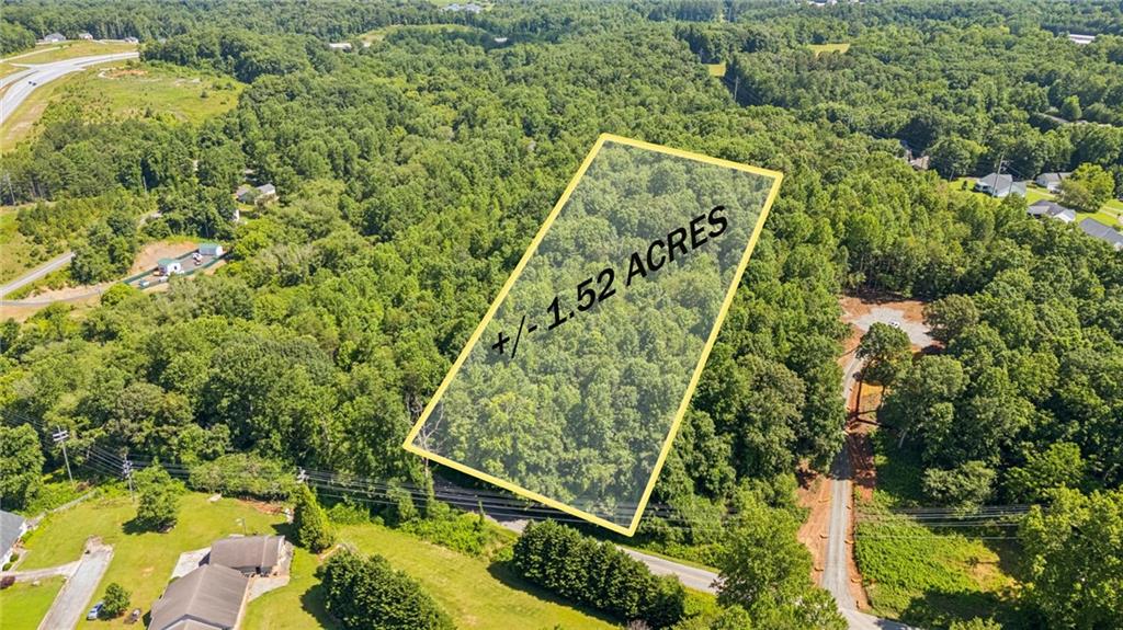 Development-Ready Opportunity: Adjacent parcel is currently under development, signaling strong momentum in the area. This property offers a prime chance to build, following a clear proof of concept for residential development and allowing you to position early in a rapidly growing corridor.
Rare 1.52-acre lot in the heart of Cleveland, GA, offering panoramic mountain views, privacy, and utilities—ideal for custom homebuilders or long-term investors. Located within city limits but tucked away in a quiet, elevated setting, this R1-Residential lot features city water, sewer, and power already available—no need for soil testing or septic installation. The land is recently surveyed and recorded, backs up to protected conservation acreage for lasting natural privacy.
Located just minutes from J.P. Nix Elementary School, local shops, and dining. With no HOA, a no-mobile-home policy, and zoning that supports future growth, this property offers a rare blend of build-ready convenience and strong investment fundamentals in a steadily developing North Georgia corridor.