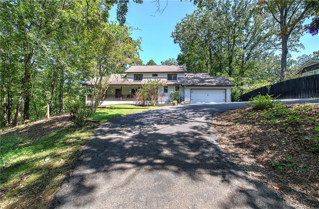 Farmhouse Charm Near Downtown Jasper. This beautifully remodeled farmhouse-style home, originally built in 1985 and fully updated in 2024, offers timeless character with modern conveniences. Ideally located just minutes from downtown Jasper, the property features a fenced yard, whole-house generator, and inviting outdoor living spaces. The main level is thoughtfully designed with a spacious primary suite complete with a cozy fireplace, a remodeled chef’s kitchen boasting an island, walk-in pantry, stone countertops, painted white cabinetry, and newer appliances. A welcoming den, powder room, and convenient laundry room with utility sink complete the main floor. Upstairs, guests will enjoy a private suite, along with an additional bedroom, home office, children’s playroom, two full baths, and abundant storage. The terrace level expands the home’s versatility, offering space for extended family with a bedroom, full bath, home gym area, kitchenette, and extra storage. A wraparound covered front porch with a porch swing invites you to relax and take in the seasons—perfect for cool fall nights. Blending farmhouse warmth with modern updates, this home offers space, function, and charm in an unbeatable location close to town.