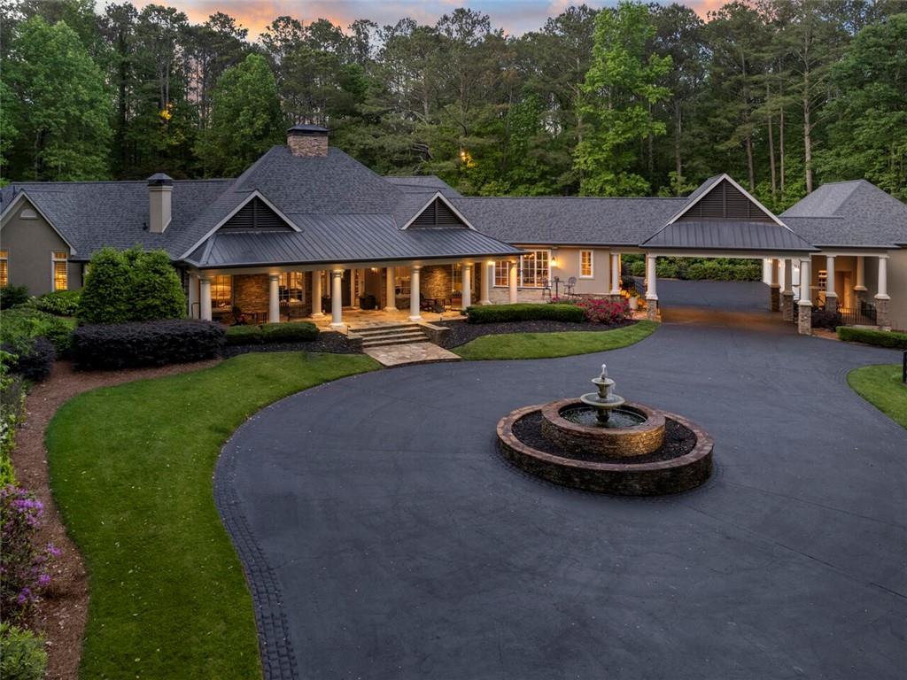 Redefine your breed of luxury! Discover Five O'Clock Farm...an iconic +/- 33 Acre Country Estate and HORSE FARM offering a blend of timeless design with exquisite quality in every detail. Coveted SE Cherokee location bordering the Little River and City of Milton at the end of of one of the most beautiful and scenic upscale country roads in all of north Atlanta. Promising an elevated lifestyle, this farm embraces absolute tranquility and graceful beauty. Architecturally stunning ranch home is understated as it extends along the landscape at the end of a private gated drive. Handsome interior finishes create a classic warmth throughout with touches of southern styling. Postcard perfect views from every room, porch and patio. One level living with easy accessibility and flow, enveloping a resort style courtyard featuring sports pool (approx 30' X 20'), spa and expanded fireside stone pavilion. A perfect setting for large gatherings of friends and family. Wide portico joins an oversized 4 car garage with extra tall/wide doors to accommodate trucks and a full use unfinished attic above. Extra pavement at the back of the home offers plenty of additional parking.
INTERIOR: Rich wood inset cabinetry in this Chef's kitchen with 6 burner/pot filler Viking(r) cooktop, oven/microwave, Subzero(r) refrigerator & wine cooler, Scotsman(r) ice maker, bar sink. Scullery back kitchen with additional Thermador(r) oven & second dishwasher, counter space & inset cabinetry. Mud room opens to portico. Primary suite with fireside sitting room and steam shower on main level as are 3 spacious en-suite bedrooms. Additional en-suite bedroom up for a total of 5 bedrooms and baths, all updated. Old world inspired stone masonry fireplace in family room is as grand as it is tall. Media/recreation room on main level with walk out access to pool, plus additional office space. Large craft or storage room upstairs.
GROUNDS AND FACILITIES: +/- 33 acres with approx 10 acres in pasture and over 15,000 linear feet of 4 board fencing around property and 4 horse paddocks. 6 STALL HORSE BARN (42'X60') with one bedroom apartment above and new deck. New electrical wiring and light fixtures in barn, freshly painted in 2023. 4 run in sheds, one in every fenced paddock; power and water run to the paddocks; Two ponds, one with aeration fountain; separate gated paved drive to barn.
ADDITIONAL DETAILS: New roof 2021 (Approx 6200 ft under roof); foam insulation in attic; 32 kw whole house generator, gas fired; majority new windows and french doors; 6 HVACS; 3 water heaters; custom fabricated automatic security gates for home and barn; new twin tank 500/1000 septic at house; natural gas; house on County water, well with new pump for barn and irrigation; 30 amp camper plug convertible to 50 amp; Comcast Xfinity business size high speed internet. Whole home indoor/outdoor Sonos audio system.
LOCATION: Country Estates area of Cherokee County is protected by land use plan, 2 acre minimum lot sizes and is known for lower property taxes as well as good schools. Easily accessible to all upscale shopping, urban centers and only 10 miles to downtown Alpharetta and Crabapple.
Property eligible for Conservation Use Valuation Assessment (CUVA) for reduced taxes if used as a bonafide agricultural property. See Cherokee County Tax Assessor for details.