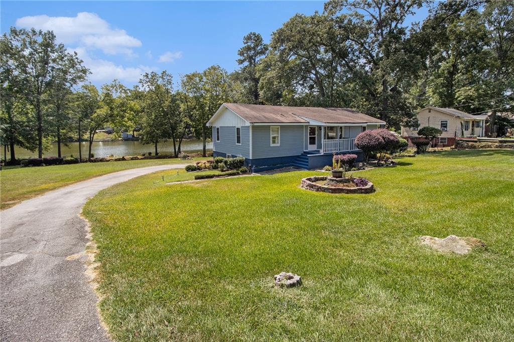 Unique property on large lot with beautiful lake view! This home has lots of updates including new paint and an upgraded kitchen with granite and large island. You'll love the sunroom with tons of natural light and lake views. Large primary bedroom. The basement has a screened porch and an additional bedroom and bathroom. 1 car garage. Lots of storage. The lot is the largest in the neighborhood and features over 200 feet of lakeshore. Don't miss your chance on this one!