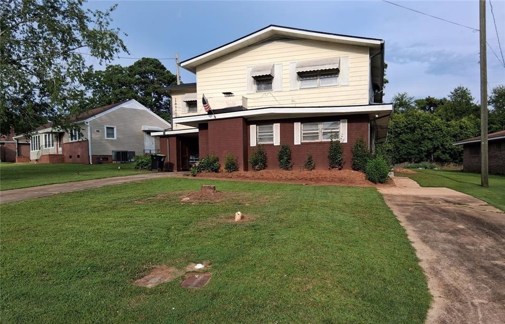 Income potential and eligible for 100% USDA no-down payment financing. This updated 6-bedroom, 4-bathroom home presents so many options in 3,760 sq ft of flexible living space. Two complete living areas—each with its own kitchen—make it ideal for multi-generational living or “live in one, rent the other.” Lock-off capable: the two floors can be separated and secured to control access. Downstairs offers four bedrooms & 3 bathrooms with tile-surround features, open sit-in kitchen, and a large den with fireplace. Upstairs features a living room/den and two bedrooms, including an oversized owner's suite with an attached office/sitting room. This is an open-concept space with a kitchen/dining area that flows outside to an enormous covered veranda with bar and metal roof—perfect for entertaining. Recent upgrades include a new architectural-shingle roof, updated kitchens and baths, fresh paint, new LVP and tile flooring, and the 2nd story outdoor bar area. Two separate driveways provide easy parking and privacy. It comes with an appliance package in both kitchens, along with washer and dryer. Can be purchased furnished for a turnkey move-in or rental setup. Sold as-is, and the seller will provide a comprehensive 1-year home warranty at closing with an acceptable offer.