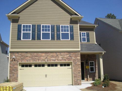Nice home with exquisite architectural details. 4 spacious bedrooms plus a big bonus room on the third floor, 2.5 baths. Fenced backyard. 2 car garage with openers. Open floor plan with tons of natural lights. Hardwood throughout main level. Granite counter tops, stainless appliances. 10FT ceiling first floor. Great schools. Only 1 mile from I-85 and the Mall of Georgia.