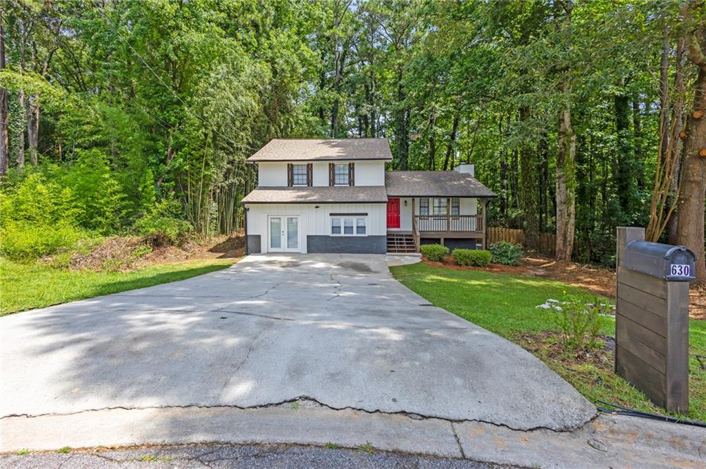 Your future home is waiting... This FULLY renovated gem is in the heart of Stone Mountain! This stylish split-level home offers a flexible layout with 3 spacious bedrooms and 2 modern bathrooms upstairs. The open-concept main level showcases a designer kitchen with an elegant island, brand-new cabinetry, quartz countertops, upgraded lighting, and crown molding that flows into a bright dining area and oversized family room. The statement quartz fireplace adds warmth and character—ideal for cozy nights or entertaining. Downstairs, a private bonus suite with its own entrance, full bath, and second kitchen offers endless potential—perfect for in-laws, guests, a home business, or rental income. Fresh interior and exterior paint, new flooring throughout, and thoughtful updates make this home truly move-in ready. Step outside to a large, fenced backyard with an expansive deck—ideal for hosting or relaxing. Conveniently located near Hwy 78, shopping, dining, and local parks, this home blends comfort, style, and income potential. Don’t miss out—schedule your tour today!