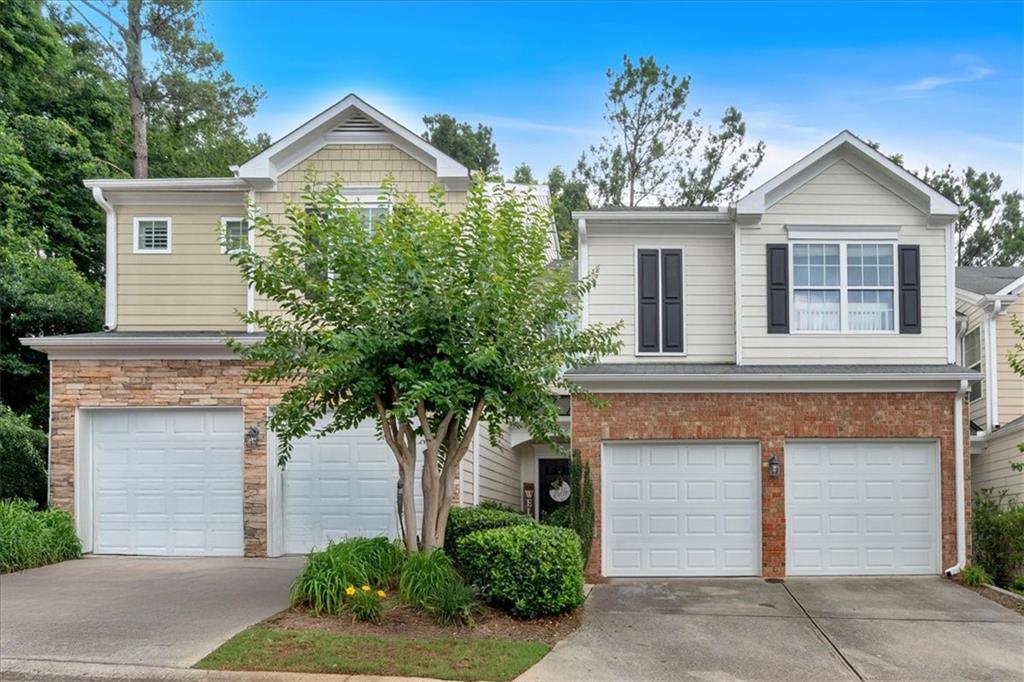 Bright, stylish, and move-in ready, this updated townhome combines modern finishes with everyday functionality in a peaceful, well-kept community. The recently renovated kitchen features granite countertops, stainless steel appliances, upgraded lighting, and a contemporary breakfast bar that opens to the fireside living room, perfect for gathering or relaxing at home. Thoughtfully designed, the main level features luxury vinyl plank flooring that adds both warmth and durability, while large windows invite in an abundance of natural light. Step outside to a private patio that backs up to quiet green space, offering a rare sense of privacy and calm. Upstairs, the oversized primary suite includes a vaulted ceiling, sitting area, spacious walk-in closet, and en-suite bath. Two additional bedrooms also feature walk-in closets and share convenient access to the upstairs laundry. The spacious two-car garage adds ease to daily life, and the community pool is just a short walk away. Ideally located minutes from shopping, dining, I-575 and I-75, and zoned for top-rated East Cobb schools, this home checks all the boxes for comfort, style, and location.