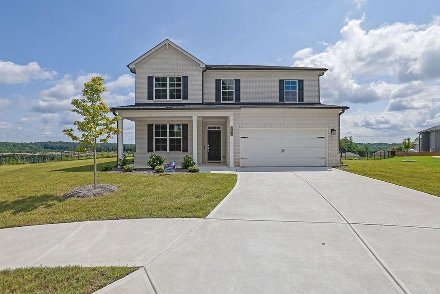 Where Your Next Chapter Begins – Welcome to Bedford Estates! Tucked at the end of a peaceful cul-de-sac in the sought-after Bedford Estates community, this stunning 5-bedroom, 4-bath home—newly built in 2023—is more than just a house; it’s the start of your next story. Step into the entry foyer, where natural light dances off rich luxury hardwood floors that flow seamlessly throughout the main level. The open-concept design is ideal for both quiet evenings and lively gatherings. At the heart of the home, the spacious kitchen is a dream come true with granite countertops, a kitchen island, gas range, stainless steel appliances, and a walk-in pantry that keeps everything organized and close at hand. The eat-in dining space is generous enough for a full-size table, and just steps away, your rear patio awaits—perfect for grilling out or enjoying your morning coffee. And here’s where this home truly shines—positioned perfectly within the cul-de-sac, it offers breathtaking panoramic views that few homes in the community can rival. These sweeping views of the treetops and skyline were so special, the current owner paid an additional $10,000 premium just to secure this lot. It’s a priceless backdrop for everyday living—but it won’t cost you a penny more. This rare advantage won’t transfer to future buyers, making it a limited-time opportunity to enjoy a one-of-a-kind setting that’s equal parts peaceful and picturesque. The family room invites you to unwind by the fireplace, surrounded by abundant windows that flood the space with natural light. Also on the main level is a flexible bedroom, ideal for a home office, guest suite, or creative studio. Upstairs, you’ll discover a secondary living area, perfect as a media room, teen lounge, or quiet reading nook. The primary suite is a true retreat, with a spa-like bath featuring dual granite vanities, a garden tub, separate shower, and an expansive walk-in closet. Three additional spacious bedrooms, two additional full baths, and a convenient upstairs laundry room complete the upper level. Outside your front door, Bedford Estates offers community amenities including a pool, tennis courts, a park, and sidewalk-lined streets perfect for morning jogs or evening strolls. And when it comes to location, it doesn’t get much better—just 15 minutes from Hartsfield-Jackson Atlanta International Airport, 20 minutes to Downtown Atlanta, and a quick 5-minute drive to Camp Creek Marketplace, where you’ll find Target, Publix, Starbucks, LA Fitness, UPS, and more. Blending modern design, versatile living space, and unbeatable convenience—plus panoramic views that no other home in Bedford Estates can claim—this home isn’t just ready for move-in… it’s ready for you. Come see where comfort, style, and community come together.