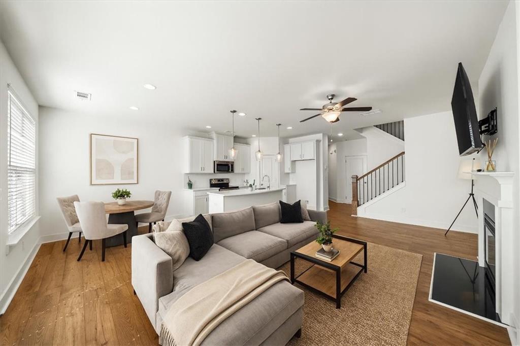 Impressive 3-bedroom, 2.5-bath townhouse in the highly sought-after Townes of Auburn community. This home has been thoughtfully updated with modern finishes and offers one of the most functional floorplans in the neighborhood. The open-concept main level features hardwood-style flooring throughout, a spacious living and dining area, and a chef’s kitchen with quartz countertops, sleek cabinetry, stainless steel appliances, and a walk-in pantry. Upstairs, the oversized primary suite includes a large walk-in closet and spa-like bath with soaking tub, separate shower, and private water closet. Two spacious secondary bedrooms, a versatile loft ideal for an office or media area, and a convenient upstairs laundry complete the second level. Enjoy your own private fenced backyard—perfect for entertaining, pets, or outdoor relaxation—plus a 2-car garage for secure parking and storage. This particular home boasts a premier location directly next to the community clubhouse, sparkling pool, and tennis/pickleball courts, offering unmatched convenience and lifestyle just steps from your front door. This move-in ready home is located just minutes from downtown Winder’s restaurants and breweries, Chateau Elan Winery & Golf, shopping and dining in Auburn and Dacula, and offers easy access to I-85 for a quick commute to Atlanta, Athens, Buford, or Lawrenceville.