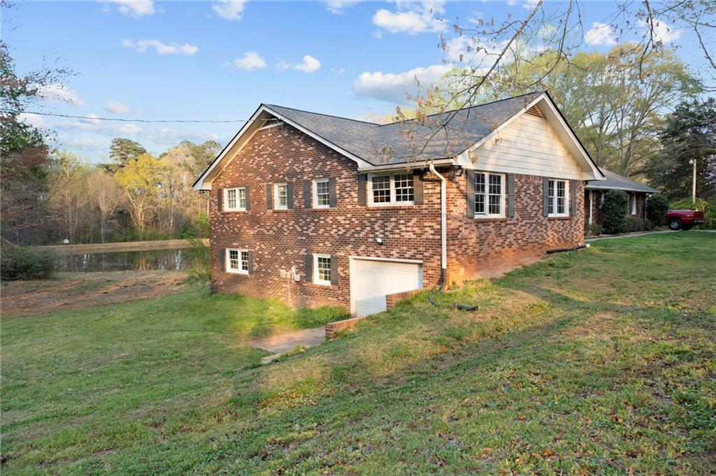 Nestled on a serene property with a spring-fed fishing pond, barn, and chicken coop, this home is the escape from the ordinary. It offers all benefits of country living with modern convenience just minutes away.
On the main level, you will find Hardwood flooring, and an inviting open-concept design. Cozy up by the wood-burning stove on chilly evenings while gazing out at the peaceful spring fed pond. Step outside onto the expansive covered back deck, where you can relax, entertain, and take in the restfull views...a perfect spot for morning coffee or evening sunsets.
The fully finished walk-out basement is perfect as a mother-in-law suite, guests, or rental opportunity. It is complete with a full bath, private bedroom, spacious living area, and stubbed out for a kitchen. There is also a workshop with boat door, for the boat, car project, or your favorite hobby!
This property is a homesteader’s dream! It has county water and well water available, with a Spring-fed fishing pond.
Lush blueberry bushes, muscadine grapes, wild blackberries and Pecan trees. The goat pasture is fenced and ready for your livestock.
And don’t forget the neighbor’s horses playfully roaming on the ajacent property, adding to the peaceful country charm. Plenty of space gardens, so you can truly live off the land. Just minutes from grocery stores, coffee shops, and dining.
This is more than a home.
Call for your private tour!