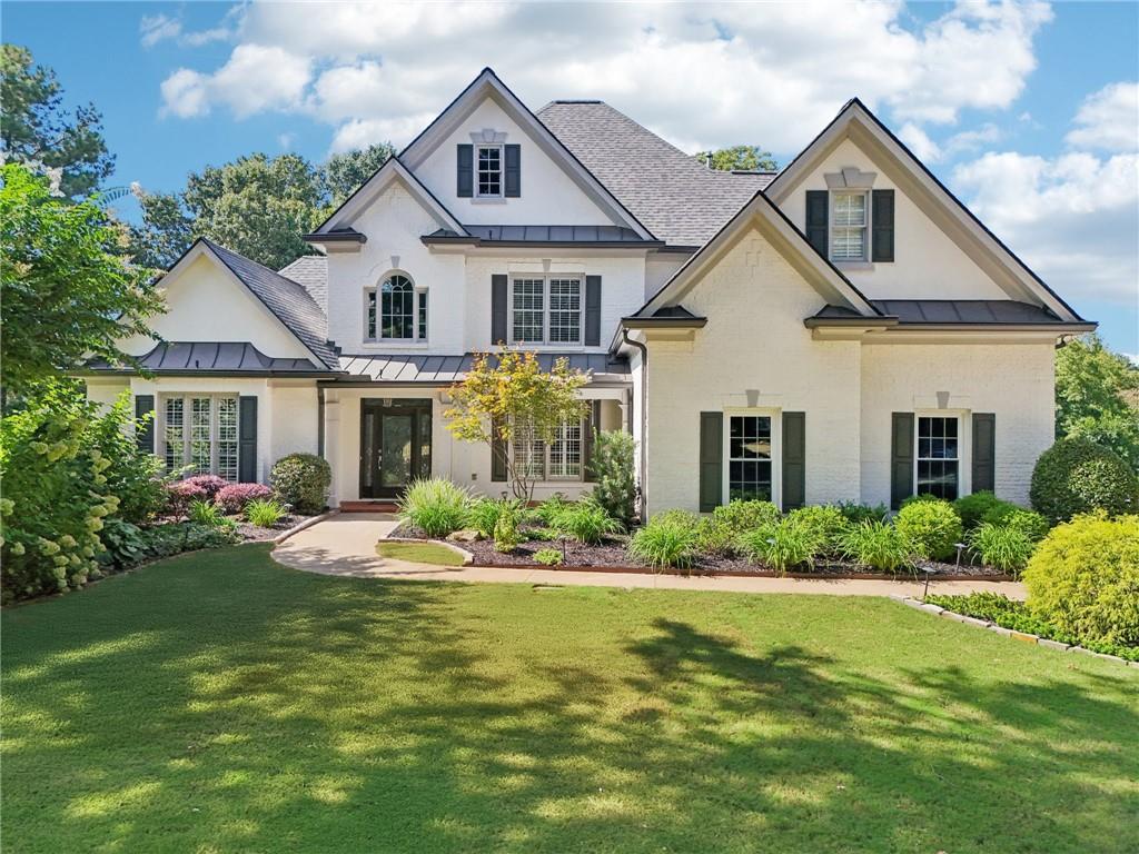 Welcome to this beautifully updated home in the highly sought-after Grand Veridian neighborhood. Nestled on three-quarters of an acre on a flat, level cul-de-sac lot, this rare opportunity offers 5 bedrooms, 5.5 bathrooms, and a three-car garage in one of the area’s most desirable communities. Step inside to a welcoming two-story foyer with tall ceilings and light-filled spaces throughout. The main level features a spacious primary suite with tray ceilings, a large walk-in closet, and a spa-like bathroom complete with a soaking tub, double vanities, and a tiled shower. An additional ensuite bedroom on the main level provides flexibility for guests or multigenerational living. Upstairs, you’ll find three generously sized bedrooms, each with its own private bathroom. The heart of the home is the updated kitchen, completely remodeled in 2023, opening to the living and dining areas for effortless entertaining. Recent renovations also include all main level bathrooms (2023), new hardwood floors (2023), fresh interior paint (2025), new carpet upstairs (2025), plus new HVAC, furnace, water heater, and front yard sod (2025). A large outdoor patio overlooks the tree-lined backyard, offering both privacy and space to relax or host gatherings. Grand Veridian is an active swim and tennis community, located just minutes from Roswell, Alpharetta, Milton, GA-400, and within a top-rated school district. With limited opportunities to own in this neighborhood, this home is truly a must-see.