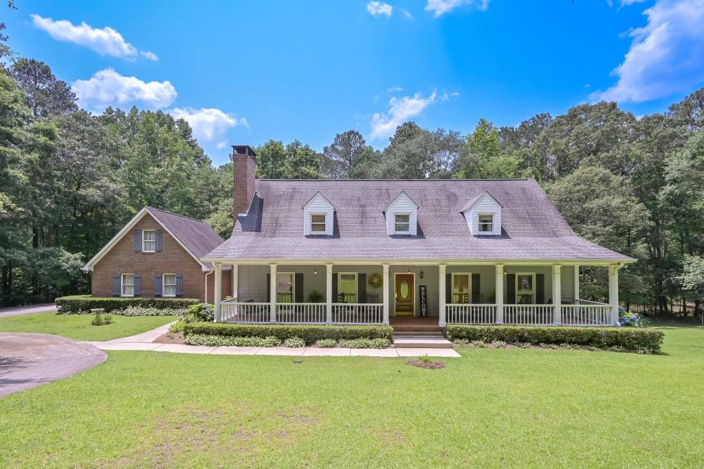 GORGEOUS CAPE COD HOME NESTLED ON 5.246 WOODED ACRES! THIS HOME IS BEAUTIFULLY LANDSCAPED AND HAS AN AMAZING OVERSIZED FRONT PORCH. UPON ENTERING THE FOYER, YOU IMMEDIATELY NOTICE THE GORGEOUS HARDWOOD FLOORS AND THEY CONTINUE THROUGHOUT THE MAIN LEVEL OF THE HOME. THE LIVING ROOM IS SPACIOUS AND HAS A BRICK WOOD BURNING FIREPLACE THAT IS OPEN TO THE FORMAL DINING AREA. THE KITCHEN HAS GRANITE COUNTERS AND PLENTY OF CABINET AND COUNTER SPACE. THERE IS A PANTRY FOR MORE STORAGE. THE HUGE BREAKFAST AREA IS OPEN TO THE KITCHEN AND HAS LOTS OF NATURAL LIGHT COMING IN. IT IS ALSO OFF OF THE LARGE SCREENED PORCH THAT OVERLOOKS THE BACKYARD. FOR CONVENIENCE, THERE IS A HALF BATH FOR GUESTS ON THE MAIN LEVEL. THIS HOME FEATURES A LARGE LAUNDRY ROOM ON THE MAIN LEVEL WITH TILE FLOORS. THE MASTER BEDROOM IS ON THE MAIN LEVEL WITH A WALK-IN CLOSET. THE MASTER BATH HAS 2 SEPARATE VANITIES WITH GRANITE COUNTERS AND ONE HAS A BUILT-IN VANITY AREA. THE MASTER BATH ALSO FEATURES A GARDEN TUB AND SEPARATE TILE SHOWER WITH FRAMELESS GLASS DOOR. UPSTAIRS YOU WILL FIND 2 EXTREMELY LARGE BEDROOMS WITH WALK-IN CLOSETS AND THEY SHARE A JACK & JILL BATHROOM. FOR ADDITIONAL STORAGE, THERE IS A FULL UNFINISHED DAYLIGHT BASEMENT WITH BRICK WOOD BURNING FIREPLACE. THERE ARE 2 EXTERIOR ENTRANCES TO THE BASEMENT AND ONE OF THOSE IS A GARAGE/BOAT DOOR FOR LAWN EQUIPMENT. THIS HOME IS VERY LOW MAINTENANCE WITH 3 SIDES BRICK, ALUMINUM SOFFITS & FASCIA AND VINYL CEILINGS ON THE FRONT PORCH. THIS HOME ALSO OFFERS SURGE PROTECTION FOR THE ENTIRE HOUSE AND A 2 CAR ATTACHED GARAGE. THIS HOME HAS BEEN WELL MAINTAINED AND IS A MUST SEE!