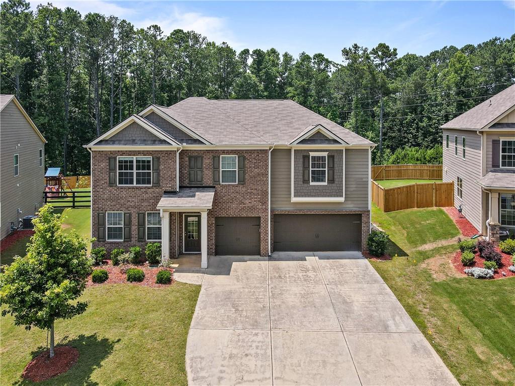 Gorgeous Home in a quiet, family-friendly neighborhood. Bright & sunny, spacious rooms throughout the house in the highly desired Top Ten Schools! West Forsyth HS, Vickery Elementary & Middle schools! Home offering all the bells & whistles with A three-car garage! The master suite is on the first floor; the Spacious Family room opens to an enormous gourmet Kitchen with an oversized island. Great size formal dining room. Hardwood floor throughout the first floor. Upstairs features a unique, oversized loft and four large secondary bedrooms. The fourth large bedroom has a private bath. You are sure to love the private, fully wooded backyard! Excellent amenities include a swimming pool, a Tennis Court, and a Playground. Conveniently close to GA 400, Shopping and Dining. Minutes to Vickery Village, The Collection, and Halcyon. 20 Min to GA Outlets!!