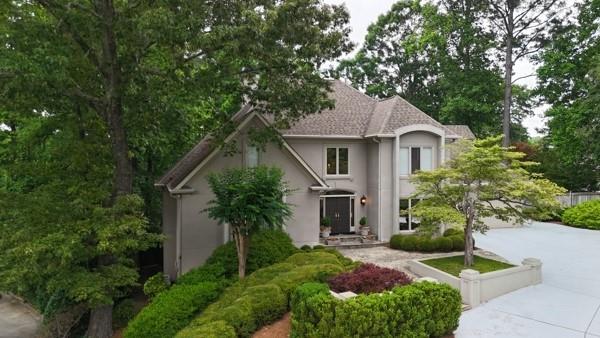 This one of a kind 1- acre executive lakefront retreat in East Cobb’s Pope High School district is a must see! The residence features lush landscaping, a secret garden, a heated saltwater pool & spa and picturesque views. The home boast gleaming hardwood floors, 3 fireplaces and a richly finished man cave. The main level features a grand two-story foyer, and a dining room equipped with a butler’s pantry and wet bar. The formal living room offers a fireplace and french doors that open to the expansive deck with beautiful views, ideal for entertaining. Another set of French doors from the deck leads into the vaulted den with a fireplace, which is open to the spacious kitchen featuring a cooks island and a breakfast area with garden views. The master suite on the main level has hardwood floors two walk-in closets and a spa bath. A laundry mudroom and a half bath complete the main floor. The second level contains 4 large bedrooms each with walk in closets.One bedroom features a renovated en-suite. While the other three bedrooms share a sizable renovated hall bath. Additionally a finished space suitable for an office or playroom on this level. There is a huge finished entertainment area in the basement reminiscent of a Scottish pub with a fireplace,bar and full bathroom. This finished area also opens to the pool deck with views to the lake. There is a second laundry room in the basement two additional large unfinished rooms with windows plus a work shop/gardening room with door to back patio. The back yard has steps down to the lake side dock/deck. The neighborhood amenities include a lakeside club house, tennis courts and a neighborhood swimming pool. For the first time in 31 years this home is being offered for sale it’s a true Gem and a pleasure to show.