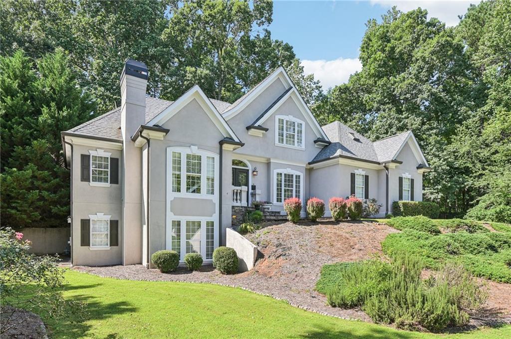 Welcome to a residence where timeless elegance meets inviting warmth, perfectly designed for your modern lifestyle. This stunning home boasts an open, airy floorplan with a soaring vaulted great room, bathed in natural light. Home features two stacked stone fireplaces-one in the great room and the main level office. Entertain with ease in the gracious formal dining room or gather in the gourmet chef’s kitchen—a culinary haven featuring a grand island cooktop, double ovens, sleek cabinetry, and stainless appliances. You’ll also find a large breakfast area that overlooks a serene backyard retreat. A main-level office with its own fireplace offers the perfect work-from-home retreat. Retreat to the exceptional oversized primary suite on the main with double trey ceilings, bay window & private entrance to the back deck. The primary bath is truly a sanctuary of luxury with dual vanities, expansive his-and-hers closets, and a spa-inspired bath with separate shower. Upstairs, two full baths & three generously sized secondary bedrooms have large walk-in closets The expansive finished basement is an entertainer’s dream. There is also additional flex space on the terrace level that can be used as a rec room, media room, gym or have another office space, plus ample unfinished space for your creative vision. Outside, a large, wooded private yard provides a serene backdrop for relaxation or play, while the vibrant community amenities—including a sparkling pool, tennis courts, playground, clubhouse, and scenic nature trail—elevate your lifestyle.
This home offers endless possibilities to craft your forever haven. Schedule your private tour today and discover sophistication with soul.