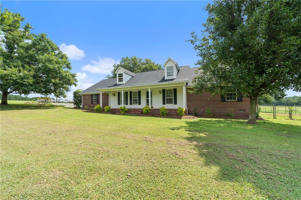 17-Acre Turnkey Farm in Monroe County - All Brick Home, Pool, Horse & Livestock Facilities, and Income-Producing Pastures Discover the best of farm life and country living on this beautiful 17-acre property in Forsyth, Georgia. A traditional brick farmhouse, this home offers 4 bedrooms and 3 full baths, blending timeless style with modern updates. The main level features 3 bedrooms and 2 baths, while the upstairs provides a spacious guest suite with a full bath, large closet, and attic access for storage. Recent upgrades include a new roof, LPV flooring, stylish lighting, and a spacious new deck perfect for outdoor living. At the heart of the home, the country kitchen boasts granite countertops, custom wood cabinetry, a portable island, bar seating, and an open layout ideal for entertaining. The great room offers warm, welcoming living space, while the sunroom opens to a Craftsman-style covered porch. Step outside to enjoy your private retreat with a pool and fenced backyard. The land features lush Alicia and Coastal Bermuda grass pastures, ideal for horses, livestock, or hay production-with income-generating potential. Equestrian facilities include a well-equipped barn with stalls, wash pad, and tack room. Additional barns and outbuildings provide ample space for hay and equipment storage, along with run-in shelters and paddocks. Whether you're looking to operate a farm, board horses, or simply enjoy the quiet beauty of Monroe County, this property delivers convenience, comfort, income potential, and opportunity. Additional adjoining acreage with pond and hay storage building is available for buyers who want to expand their vision.