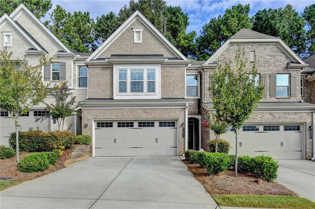 Beautiful 2-story townhome offering 3 bedrooms and 2.5 baths! Hardwood floor on main level and stairs. Gourmet kitchen with large granite island, SS appliances, gas cooktop, and ventilator that makes cooking more joyful. Open to family room/dining area with a walk to patio and private backyard. Oversized master suite upstairs with trey ceiling, spa bath that boasts oversized, tiled shower, separate garden tub, and double vanities. Great-sized secondary bedrooms. Secondary bedrooms share generously sized hall bath. Paint has been refreshed. Gated neighborhood with a large swimming pool. Great Location! Easy and Convenient access to shop, restaurant, I-985, and Mall of GA.
