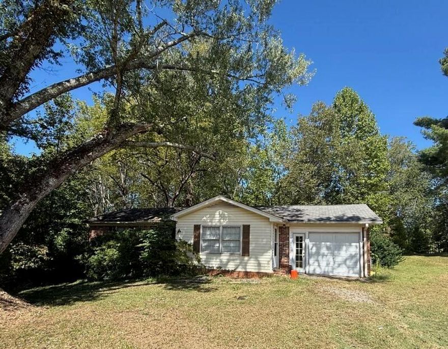 Estate owned stepless brick and vinyl ranch on a level corner lot.  Open floorplan.  Private bedrooms and large living area. This home is convenient to Dahlonega and the vast number of surrounding wineries.  With a little love, this will be someone's dream home.  Large walk-in crawl space for storage.