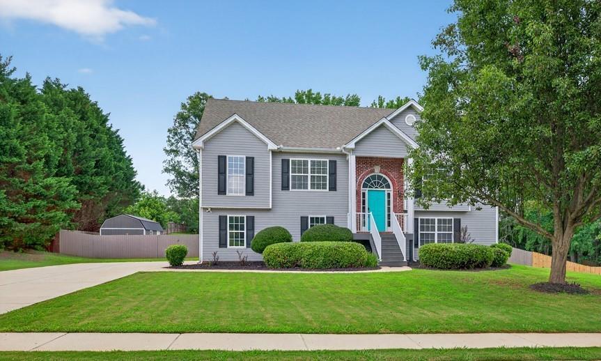 EXCELLENT VALUE! JEFFERSON SCHOOLS! 4 BR PLUS LARGE BONUS/REC ROOM. BRAND NEW COMPOSITE DECK AND UTILITY BUILDING FEATURING WINDOWS, ROLL UP DOOR, AND ELECTRIC OPTION (purchased 1 year ago). Perfect layout for teen suite/ multigenerational living with a full bathroom, bedroom, and generous size flex room to be used anyway you like with access to the outside. Main floor features split bedroom plan and 2 full bathrooms. Large 2 car garage also has a separate storage room perfect for workshop, lawn equipment, seasonal storage. Fantastic fenced in back yard and community pond nearby. Located in desirable neighborhood and all less than 5 miles from award winning Jefferson City Schools and I85. Also nearby grocery, restaurants, and local downtown with walkable shops and dining. Don't wait! Schedule your showing today.