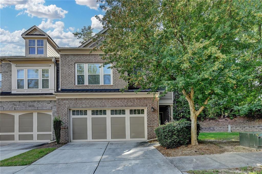 Welcome to this gorgeous 4-sided brick END UNIT townhome in Milton/Alpharetta, GA, situated within a prestigious gated community right down McGinnis Ferry from the soon to be open GA 400 on ramp! Main living space has open floor plan with hardwoods throughout and french doors that lead out to patio, perfect for all of your entertaining needs. Very spacious kitchen offering stainless appliances, loads of cabinets space, breakfast bar and granite counters. The living room offers plenty of space to gather friends and a cozy fireplace. Upstairs you'll find a very spacious primary suite, with vaulted ceilings, luxurious spa-like bath, granite counters, tile floors and lots of closet space. Two spacious secondary bedrooms. This home has a 2 car garage.