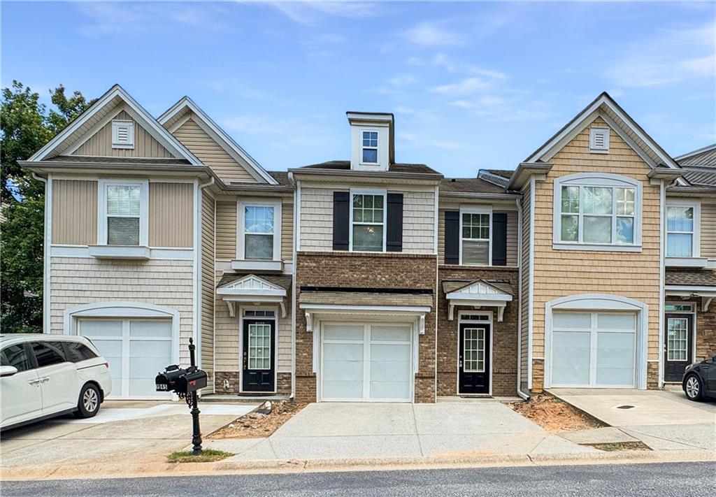 Move-In Ready Townhome in Prime Location! Freshly updated with new interior paint, new LVP flooring in the foyer, kitchen, laundry & all 3 bathrooms. this spacious townhome is located just minutes from I-85, shopping, and top dining spots. The roommate-style floor plan offers two oversized bedrooms, including a secondary bedroom with a bonus sitting area—perfect for a home office or lounge space. Enjoy an open-concept layout where the kitchen flows seamlessly into the spacious family room and dining area, ideal for entertaining or relaxing at home. The unit comes fully equipped with a refrigerator, washer, and dryer for your convenience. Situated directly across from the clubhouse, resort-style swimming pool, and playground, you'll love having these amenities just steps away.
