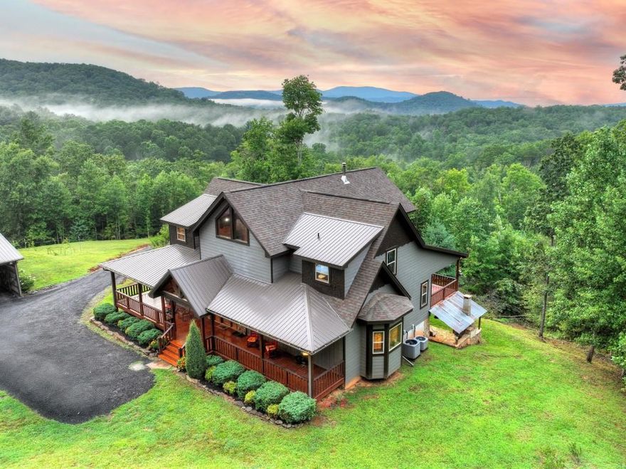 Privately tucked away on over 27 pristine acres, this custom-built 5 bedroom, 5.5 bath chalet captures breathtaking long-range views of the Blue Ridge Mountains. Surrounded by nature and bordered by USFS land, the property offers unmatched privacy with a serene creek meandering through. Designed for both comfort and style, the home features a soaring great room with a wall of windows to frame the mountain vistas, a floor-to-ceiling wood burning stove, and a spacious loft. Each bedroom is en-suite, providing luxurious privacy for family and guests. The gourmet kitchen boasts custom cabinetry, premium finishes, and an open flow perfect for entertaining. After a day outdoors, unwind in the indoor sauna, gather at the outdoor stone fire-pit under the stars, or fire up the built-in BBQ for mountain-side dining. A large barn/workshop offers endless possibilities for hobbies, storage, or equipment. With a mix of rolling pasture, hardwood forest, and creek frontage, the land is ideal for exploring, recreation, or simply enjoying the peaceful surroundings. A rare opportunity to own a true mountain retreat crafted by the builder for himself and his family with uncompromising space, privacy, and custom craftsmanship-just minutes from all the beauty and adventure the Blue Ridge area has to offer.