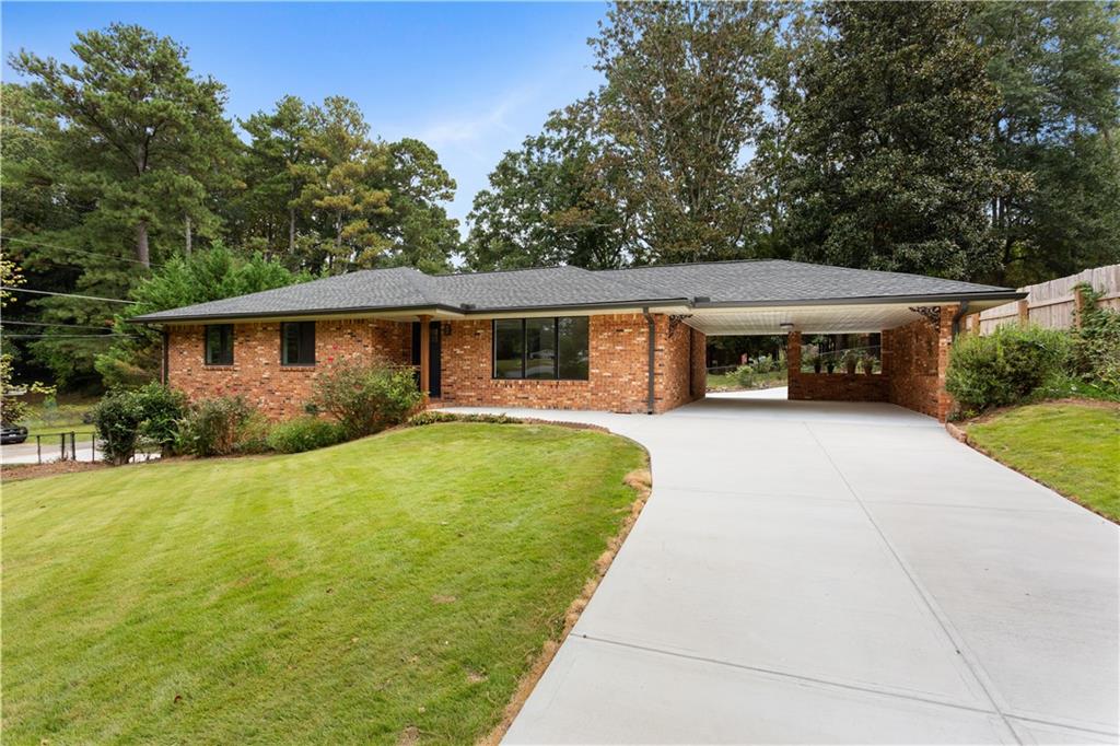 Step into timeless charm and modern comfort in this beautifully renovated brick ranch nestled on a spacious corner lot in a desirable location close to the E/W Connector. Everything old is new again as this home has been remodeled top to bottom stem to stern. If you love the charm of an older home but dont' want the mainenance or the projects, you need look no further. This home has: new roof, new gutters, new windows, new HVAC system and that's just the "systems". This home sports a spanking new kitchen with new LG appliances, quartz countertops & tile backsplash, refinished hardwood floors, new cabinetry in the baths with updated tile flooring, new lighting and ceiling fans. Oh my, it even boasts of new doors, hardware, & light switches. The property also offers a carport at main level and a drive under garage with basement for storage or workshop. This beautiful corner lot offers a zoysia lawn that begs you to sit outside and enjoy nature. The driveways are new too. Is there anything else you can ask for. Oh, yes, an easy commute to the airport or downtown or the Galleria area. Lovingly renovated and designed by professionals, you'll see that this home offers quality and style that you can just enjoy for years to come. You can move in here and just enjoy life and your new home.