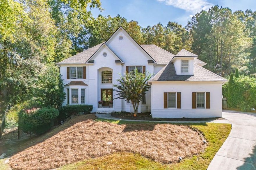 Elegantly tucked at the base of a picturesque cul-de-sac, this exquisite residence is perfectly positioned on a prime 1/2-acre lot in the heart of Sandy Springs, GA. A warm, light-filled interior welcomes you upon entry, setting the tone for refined living and effortless comfort.  The main level showcases a true open-concept design, ideal for both grand entertaining and relaxed everyday living. At its center lies a chic, beautifully updated kitchen that flows seamlessly into the surrounding living spaces. A spacious office/bedroom on the first floor, situated adjacent to a full bath, offers exceptional flexibility-whether as a private home office, guest suite, or serene retreat.  Upstairs, the expansive primary suite features a luxuriously updated bathroom and generous closet space, creating a peaceful haven. Three additional bedrooms are bright, airy, and thoughtfully proportioned, providing comfort and style for family or guests.  The home also offers a large basement with abundant storage and framing already in place-an excellent opportunity to customize and expand. Just off the two-car garage, a well-designed drop zone provides a convenient and organized space for coats, bags, and everyday essentials.  Perfectly situated in a coveted Sandy Springs location near Dunwoody, this home offers exceptional access to top-rated schools, premier grocery stores, and an array of acclaimed restaurants-bringing both convenience and lifestyle to your doorstep.