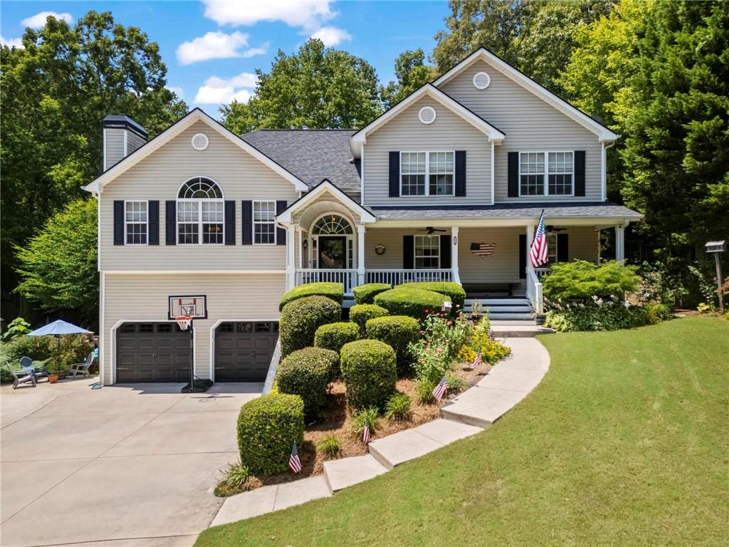 This beautifully maintained split-level home in the sought-after Etowah School District offers a versatile floor plan, modern updates, and plenty of space for everyone. The main level features a spacious primary suite with a sitting area, large secondary bedrooms, and updated light fixtures throughout. The bright and inviting living area boasts vaulted ceilings, a cozy fireplace, and built-ins that add both charm and functionality. The kitchen includes a subway tile backsplash, newer appliances, and two new storm doors. The fully finished basement, completed in 2020, offers a gym, full bath, bedroom, and living area with kitchenette—making it ideal for an in-law or teen suite. Major updates include a new roof (2018), new garage doors with openers (2019), new water heater (2021), new garbage disposal, and an insulated and sealed attic with a tent cover for improved energy efficiency. The garage walls and floor have been freshly painted, and an additional parking pad has been added for convenience. Outdoor living is a true highlight with a private above ground pool, a rocking chair front porch that spans the length of the home, a fantastic yard perfect for entertaining, and space to enjoy all four Georgia seasons. The property also includes a replaced and painted deck, backyard shed, and the added bonus of NO HOA. Built-ins in the laundry room and thoughtful updates throughout make this home completely move-in ready. Conveniently located near shopping, dining, and top-rated schools, this home truly has it all!