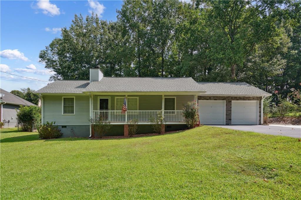 Welcome to your dream home in the charming community of Sugar Hill, Georgia! This meticulously maintained residence offers a comfortable and inviting living space and a location that puts you right at the heart of everything this vibrant area has to offer. Nestled within easy reach of Atlanta, this home provides convenient access to the bustling city while maintaining a serene suburban atmosphere. Commuters will appreciate the proximity to the interstate, ensuring a smooth journey to and from work or weekend adventures. Upon entering, you're greeted by an inviting stone fireplace and the comfort of new LVP flooring creating an atmosphere of spaciousness and warmth. The view from the living/dining room to the large back porch offers the perfect setting for hosting gatherings and special occasions. The level driveway and backyard provide both convenience and functionality, offering plenty of outdoor activities and relaxation space. This home features a luxurious primary bedroom with a large, full bathroom. Two additional bedrooms and a bathroom. Convenient a two-car garage with a storage room and TV. A large, lush-fenced backyard with a fire pit and gazebo. This home offers ample storage and outdoor living opportunities. Recent updates include new appliances, gutters with leaf guards, and a new washer and dryer. Beyond the comforts of home, Sugar Hill and its surrounding area offer many activities and amenities to explore. From parks and recreational facilities to shopping, dining, and entertainment options, there's something for everyone just moments away.