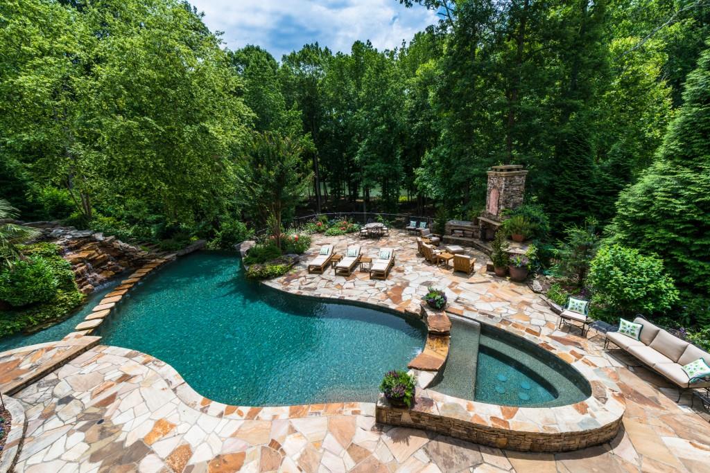 Magnificent property in Johns Creeks most prestigious gated golf community. This home is a masterpiece and has just been redone in the past year. Stunning main floor with two story foyer and double staircase leads to elegant formal rooms. Large custom kitchen opens to beautiful family room with picture windows overlooking the resort like pool and the river beyond. 5 generous bedroom suites upstairs and master on main. Enviable terrace level with perhaps the best "man cave" - secret room!! Second kitchen, gym, wine cellar, 4 car garage, elevator - a true "palace"!!