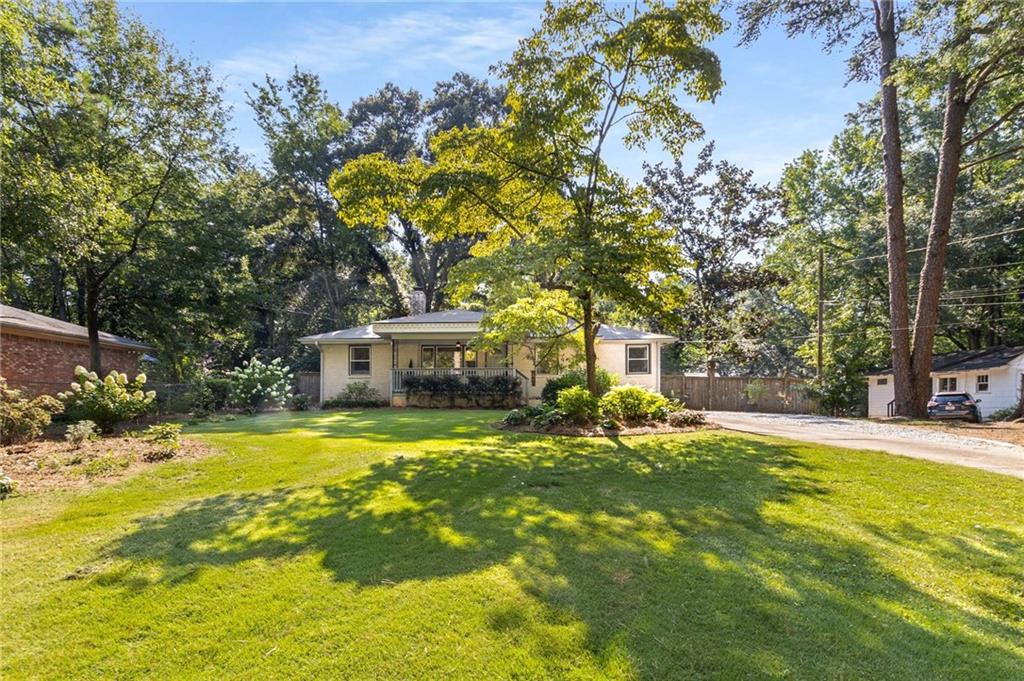 Reintroducing 516 Quillian Avenue: If you missed out the first time, here’s your second chance! 516 Quillian went under contract within days, but due to buyer financing falling through, it's back and ready for its next lucky owner. This charming East Lake gem offers 4 bedrooms, 2 bathrooms, and an open floor plan designed for today’s lifestyle. Hardwood floors flow throughout, creating a warm and welcoming vibe from the moment you enter. The spacious kitchen and main living areas are perfect for everyday living or entertaining. Step outside to a large, level, fully fenced backyard—ideal for weekend BBQs, kids at play, or pets roaming freely. A brand new 2025 roof and fresh landscaping add peace of mind and boost the home’s curb appeal. Wait there's more! With just minutes from top-rated restaurants, local boutiques, coffee shops, grocery stores, parks and easy access to major highways, location is prime. Plus, this home qualifies for a lender paid 1% rate Buydown. Call Laura Witte, 404.456.8291, with Highland Mortgage. Just when you thought it couldn't get better-it does. As an added bonus, the neighboring lot at 520 Quillian Avenue is included in the sale. Don’t miss your chance to make this East Lake beauty your own.
