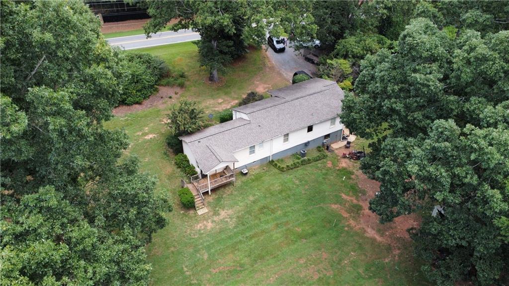 Nestled in the highly sought-after City of Milton, this one-of-a-kind farmhouse sits on a beautiful, private 1-acre lot, offering peace and serenity while still just minutes from all the popular shops, restaurants, and entertainment in both Milton and Alpharetta. With no HOA, this property provides endless possibilities—whether you envision a garden, a mini-farm, or simply space to breathe, this land is ready for your dreams. Step onto the inviting rocking chair front porch and into a home filled with character and charm. Inside, you'll find unique moldings, built-ins, real hardwood floors, and a quaint sun porch perfect for morning coffee or afternoon reading. The spacious primary bedroom offers stunning views of the surrounding landscape and includes a private ensuite bath for comfort and privacy. Located in a top-rated school district, this is the perfect location to enjoy the best of both rural tranquility and city convenience.
Being sold As Is – don't miss this rare opportunity to own land and charm in one of North Georgia’s most desirable areas. Whether you are looking to add another property to your rental portfolio, build a custom new home or even a few, this listing is your ideal property.