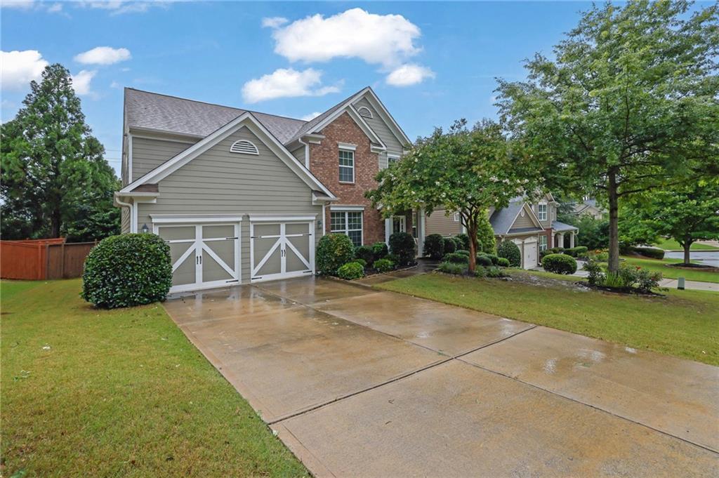 Tucked just off Highway 92 in the beautifully maintained neighborhood of Madison Falls, this Cherokee County gem offers quick access to East Cobb, Roswell, I-575, GA-400, and the Peach Pass lanes. Within minutes of several highly rated schools, community parks, places of worship, nature trails, and fitness clubs, this five-bedroom, three-bath home features a dual fireside sunroom located just off the open, naturally lit, soaring great room. The open kitchen includes a walk-in pantry, small island, and breakfast area that flows directly into the heart of the home, all functionally yet seamlessly connected to the large open formal dining room. Directly across from the dining room, you'll find a private office or study with custom built-in shelving. When touring, be mindful not to overlook the private guest bedroom on the main level and the full bathroom, which offers guests a completely private space. Upstairs, the oversized primary bedroom includes a highly functional custom closet and an open area large enough to serve as a sitting space, workspace, or nursery. With high ceilings and generously sized rooms throughout, this home feels much larger in person than photos or measurements could capture. Within the last two years, the exterior has been freshly painted and the water heater replaced, and the roof is less than three years old. The HVAC has been regularly serviced, and the low-maintenance yard offers a great canvas for your personal touches. A short drive from the entrance puts you at your front door, and a short walk from the home leads to the community pool and playground. With an abundance of nearby shopping, dining, and grocery options—including the Outlet Shoppes and most major retailers within a five-mile radius—running daily errands or planning evenings out in this special part of Woodstock is even more convenient than one might imagine.