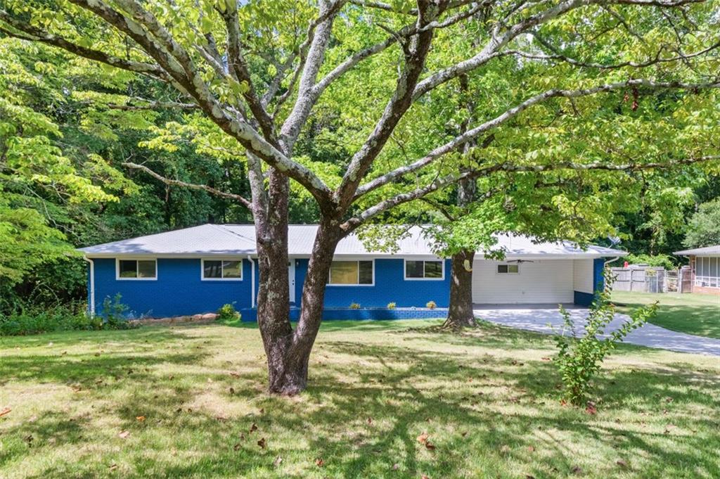 ** Join us Sat August 2nd from 12-2pm** Welcome to this completely renovated 4-bedroom, 4 FULL bathroom ranch-style home with a fully finished basement suite, offering over 3,400 sq ft of living space on a .27-acre lot in a quiet neighborhood, conveniently located right off of I-75. Every inch of this home has been thoughtfully upgraded for peace of mind and modern comfort: *NEW* electrical wiring throughout home, *NEW* electrical panel, *NEW* stainless steel appliances, *NEW* water heater, *NEW* cabinets with quartz countertops in the kitchen, *NEWER* HVAC system, *NEWER* roof, *Completely waterproofed* basement from the exterior, with water redirected away from the home—includes 10-year transferable guarantee. Step into an open-concept main level with beautiful original hardwood floors, spacious living and dining areas, and a chef’s kitchen designed to impress. The primary suite features a luxurious soaking tub, double vanity, and generous layout. Two of the four bedrooms have en-suite bathrooms, offering ultimate privacy and convenience for guests or family members. The basement level doubles as a full apartment suite complete with its own bedroom, bathroom, living space, and exterior exit—perfect for multigenerational living, guests, or rental potential. Enjoy outdoor living in the clear, level backyard, easily accessible from the mudroom that leads to the back deck. A mini carport area includes additional storage space, making organization simple. With each bedroom offering its own bathroom, a bright and open layout, and major system upgrades already completed, this move-in ready gem delivers both comfort and long-term value in an unbeatable location.