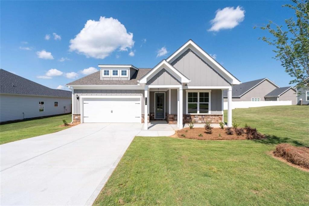 Franklin D2 #48 - an Amazing 3/2.5 Craftsman Style Ranch Home. Approaching the home, you will be welcomed by a Front Porch with Columns. This home offers an Open Concept kitchen, dining and family room with high ceilings. The kitchen features 42" cabinetry, granite countertops, tiled backsplash, an enormous island with pendants, stainless appliances, walk-in pantry, LVP and ceramic tile flooring and garage door opener. Primary Suite with ceiling fan, double vanities, oversized tile shower with bench, and walk-in closet. Double doors leads you to a rear patio overlooking a large private backyard that is great for entertaining family and friends. In close proximity is Jackson Lake for all your water activities such as boating, jet skiing, fishing and much more. Jasper County school system. Convenient to Covington, Conyers, McDonough and I-20. 100% Financing available. WOW!! Seller will contribute Up to $15K when Buyer uses a Preferred Lender. Listing contains stock file photos. File Photos shown of similar home and for representation, however, some features may differ. Call TODAY to schedule a tour.