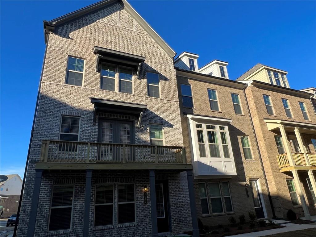Modern Townhome attached to the much sought after Town Center in Peachtree Corners. Lock and leave lifestyle. Enjoy walking to Dinning, Shopping, Grocery stores, Playground and Movie. Enjoy the live outdoor concerts and seasonal events at the Park. This beautiful three-story END UNIT townhouse features 3 bedrooms, 3.5 bathrooms with lots of natural light and oversized deck. The open concept living area designed for both relaxation and entertainment, featuring fireplace seamlessly flows into the dining area and gourmet kitchen. Magnificent kitchen features white cabinets with glass door, Quartz counter tops, huge island, stainless steel appliances. 10-foot ceilings on main and 9-foot ceilings on all other floors, Built-ins. Dual Master bedrooms. Main owners suite with elegant bathroom and oversized shower. Large laundry room upstairs. Perfect finished lower level with 2 car garage and guest bedroom with full bath. Beautiful durable engineered 7" vinyl plank flooring on main level and upper stair hall with oak stair treads. Walking distance to The Forum on Peachtree Parkway. Owner requests excellent credit 740+ and 3x monthly rent income to qualify.