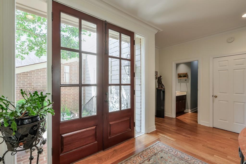 Exceptional views of the Chattahoochee River are yours to enjoy from multiple areas of this beautifully updated and open plan home. Enter through a custom made wrought iron gate into a private garden courtyard that leads to the brick and hardiplank home's covered front porch. Double glass entry doors open into a large foyer which leads to the 2-story great room with gas fireplace on one side and the kitchen, sitting area and dining room on the other. Walls have been removed and widened to create the open living and entertaining spaces which have access to the expansive back deck. The main level with gleaming hardwood floors has an additional room currently used as an office but it could be converted into a 4th bedroom. The powder room on the main level has the ability to be a full bath which has been done in several other River Plantation homes. A stunning circular wrought iron staircase leads to 3 upstairs bedrooms and 2 full baths. The primary bedroom has a sitting area with gas fireplace, an upgraded wall of windows and doors opening to a wide deck with river/wildlife views. The spa like primary bath has double sinks, luxurious walk-in shower, soaking tub and large walk-in closet with an additional spacious closet located off the bedroom's entrance hallway. Two additional bedrooms have larger closets and plantation shutters. The stairway landing can accommodate a sitting or study area and there is a generous storage/linen closet nearby. The home has been meticulously maintained, 2 HVAC systems and hot water heater are less than 3 years old, Roof is 2 years old. There is plenty of work space in the garage and a large storage closet. ***Important feature of this home is the masonry firewalls between each unit*** Not only a fabulous home but a fabulous lifestyle! Literally steps away are National parks with popular hiking, biking and walking trails. Abundant shopping, restaurants and major roadways are nearby. Award winning Walton High district.