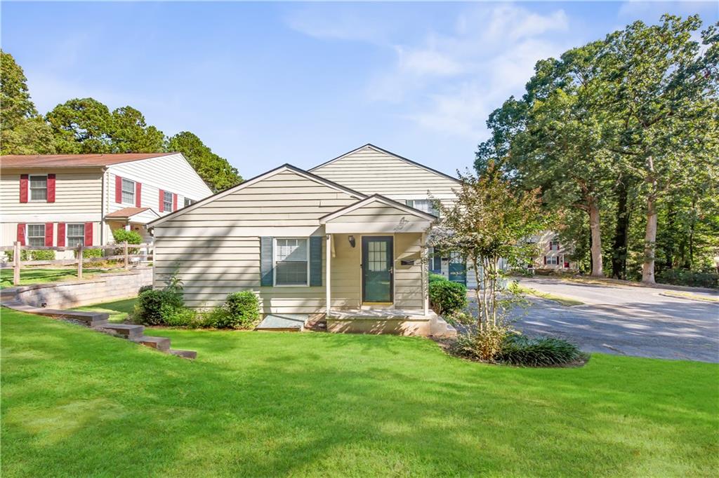 Discover endless activities and modern comfort in this affordable 2 bed / 1 bath, 810 sq. ft. ground-level end-unit condo offering the ease of single-floor living located in the back of the complex with no through traffic creating a semi-private space just minutes from Marietta Square, Truist Park, Kennesaw Mountain, and more. Featuring an open floor plan with abundant natural light, updates include newer flooring, windows, doors, and a beautifully refreshed kitchen with stainless steel appliances, breakfast bar, and upgraded lighting. Two bedrooms share an updated bath, while multiple closets, a walk-in, and a detached garage with opener provide ample storage with tall ceilings. Enjoy morning coffee on the front porch overlooking the semi-private yard. The HOA covers water, sewer, trash, pest control, exterior maintenance, lawn care, and access to a dog park—offering a convenient, low-maintenance lifestyle in a highly sought-after location.