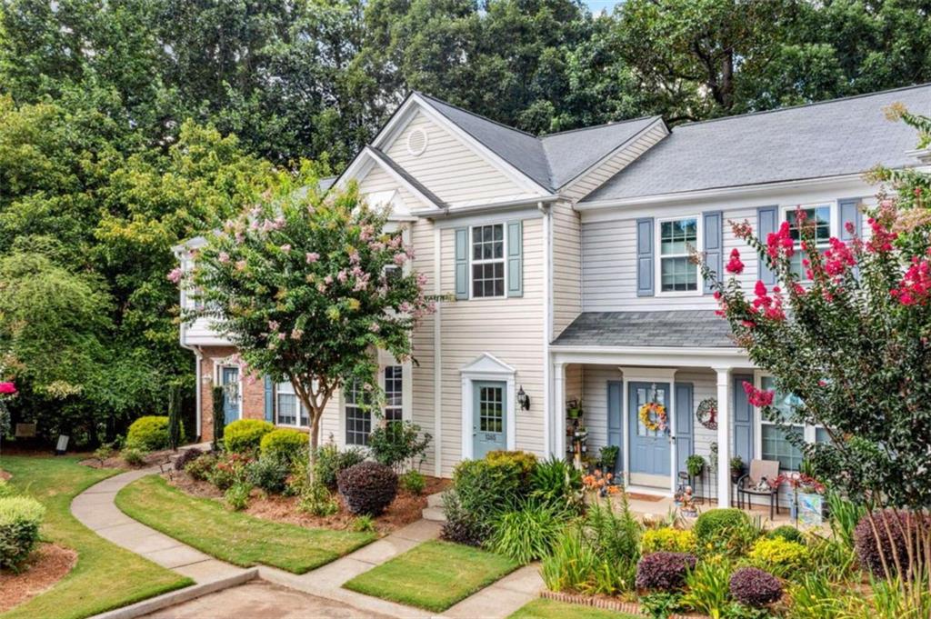 Best Priced townhome in Alpharetta With all the conveniences & Alpharetta perks: Direct access to Alpharetta's Greenway Trail System, minutes to shopping & entertainment at the posh Avalon, Whole Foods Market, Alpharetta City Center events, and GA-400, plus YMCA swimming pool & fitness & top-rated city schools. This home features Many UPDATES to include Roof, HVAC, & Water Heater, Nest thermostat & smoke detectors, plus freshly neutral painted interior, light fixtures, gleaming hardwood laminate floors throughout with NO carpet, plus kitchen and bath finishes. On the main level you will find a light-filled living room with a gas fireplace and powder room. The open concept kitchen and dining area include a breakfast bar, pantry, wooden white cabinets, tiled backsplash, Stainless Steel appliances, and granite counters. Upstairs you will find a laundry closet with washer and dryer that stays, linen closet, two secondary rooms that share a full bath, and the spacious primary suite with vaulted ceiling, dual vanity, tiled shower with large soaker tub, new vinyl tile floors, and a walk-in closet. To top it off, peace of mind living in the well-maintained StoneRidge which offers lawn care, dog-walk pond, termite bond, and water. Two parking spots are included with plenty of nearby visitor parking spaces.