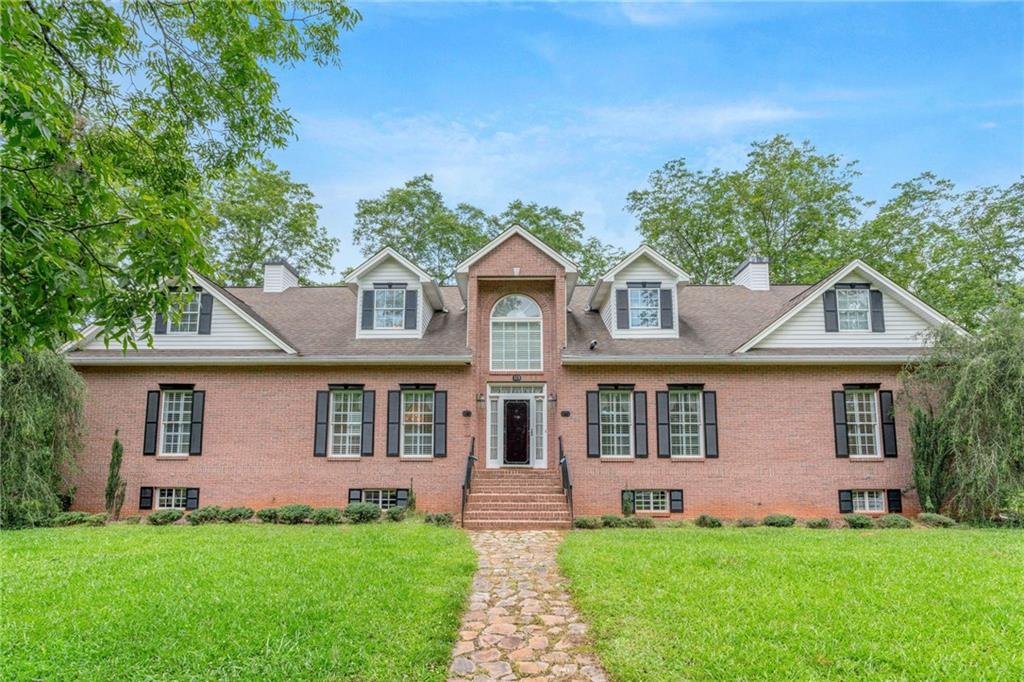 Stunning Custom-Built 4-Sided Brick Home on 5 Acres with Pecan Orchard
This beautifully maintained, custom-built brick home offers an impressive over 4500 square feet of living space and over 2900 square feet of basement. Situated on 5 picturesque acres featuring a mature pecan orchard, this property blends classic charm with modern functionality and comfort.
Inside, the home boasts 4 spacious bedrooms, 4 full bathrooms, and an abundance of flexible living spaces, including 2 large bonus rooms and a dedicated storage room. The main-level primary suite is a luxurious retreat featuring crown molding, a trey ceiling, a private dressing room, a gas-log fireplace above the soaking tub, a separate shower. The expansive kitchen spans the length of the home and is equipped with two pantries, a charming eat-in area with a bay window and built-in bench, and an adjacent laundry room for convenience. Generously sized separate dining and living rooms make this home ideal for entertaining. and direct access to a covered porch through elegant French doors. The lower level includes a 2-car garage, 2 finished rooms that could serve as additional bedrooms, a second laundry area, and ample space for hobbies or a home office. Upstairs, you'll find 2 additional bedrooms and a full bath, perfect for accommodating family or guests. Additionally, the home features central vacuum, 2 hot water heaters, well water in addition to public water, entertainment center is wired for sound with flush mounted ceiling speakers and plantation shutters. Minutes to downtown Barnesville shops and restaurants.
With its versatile layout, elegant details, and peaceful setting, this exceptional home offers room to grow, entertain, and enjoy the beauty of country living—all just a short drive from local amenities.
This home was built with care and attention to details, stairs built with extra support to prevent noise, additional interior wall insulation, cedar lined closet upstairs and much more. You'll see for yourself...