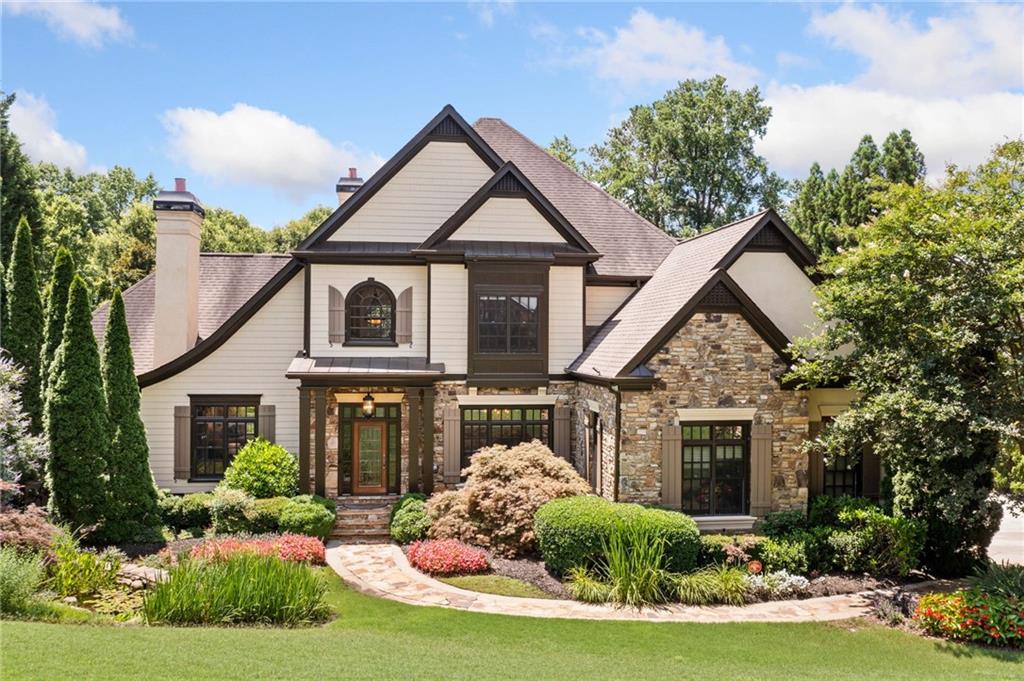 This luxurious Estate home is a true showstopper perfectly positioned on a private lot with breathtaking views of Sope Creek. Nestled on a serene 1-acre lot overlooking the winding creek, this exceptional property is designed for both grand entertaining and peaceful retreat. Boasting two stunning pools and a full turf backyard perfect for summer gatherings and twilight soirees the home seamlessly blends outdoor beauty with refined interiors. The Master suite on the main level offers comfort and convenience, with a tranquil sitting room overlooking a private water feature and a stone fireplace. The large Sunroom with panoramic view of the postcard-worthy backyard invites you to bask in the sunshine and relax. A fully finished basement expands the living space to accommodate friends and family with a Golf simulation room, a home gym, secondary laundry room, and an additional guest suite. With elegant finishes, generous square footage, and unmatched natural surroundings, this home is a rare blend of sophistication, serenity, and fun all wrapped into one remarkable estate. This Estate home is a MUST-SEE!