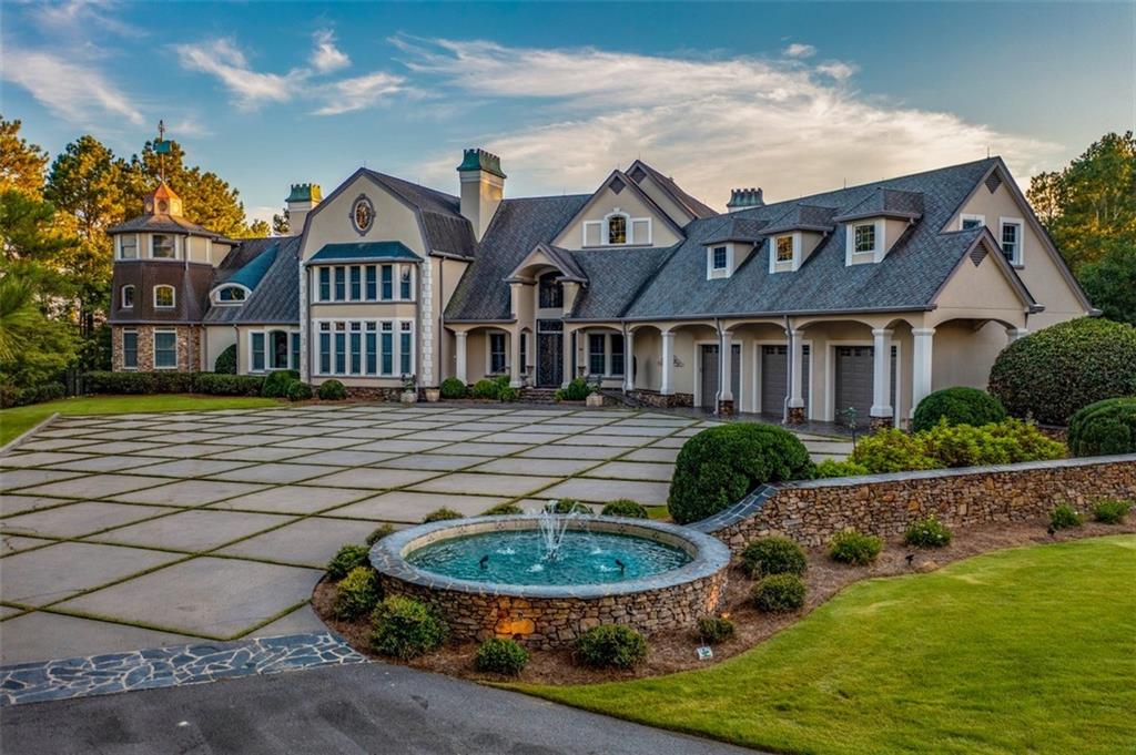 This Outdoor Paradise features 120 acres with all the wildlife north Georgia is famous for including Wild Hogs, Black Bear, Turkey and multiple herds of deer. This old style Architectural shingled home boasts 6 bedrooms and 11 bathrooms and an amazing grand foyer with its 29 foot ceiling. Exhibiting a custom crystal chandelier, the grand staircase will be the most remembered feature of this impressive home. The master bedroom features a floor to ceiling stone fireplace with a larger than life Trey Ceiling featuring a custom painted façade. The adjacent master sitting area boasts an impressive floor to ceiling wall of windows, reaching upwards of over 25 feet. This unequaled property offers long range mountain views and 4 stocked ponds with seasonal trout, largemouth bass and bluegill. The first class kitchen features a large island, Wolf Stove with six gas burners and a Sub-Zero Refrigerator. The large entertaining patio area features a 12 ft. deep oversized pool and the southern portion of the pool house features a large outdoor kitchen featuring over 900 sq. ft. of outdoor grilling and entertaining area. The home has an Advanced Carrier HVAC system that includes a state-of-the-art electronic filter system with high efficiency units that are zoned for every room. The utility bills are substantially lower than comparable sized homes due to the interior walls and ceilings sprayed with Closed Cell Spray Foam for maximum energy efficiency. The large metal building features a well-maintained apartment and additional storage areas for boats, campers, or tractors.